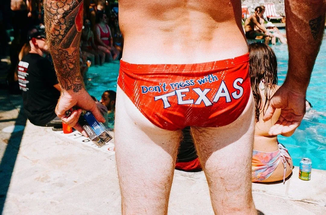 Picture of a male behind in a speedo. Speedo says "Don't Mess With Texas"