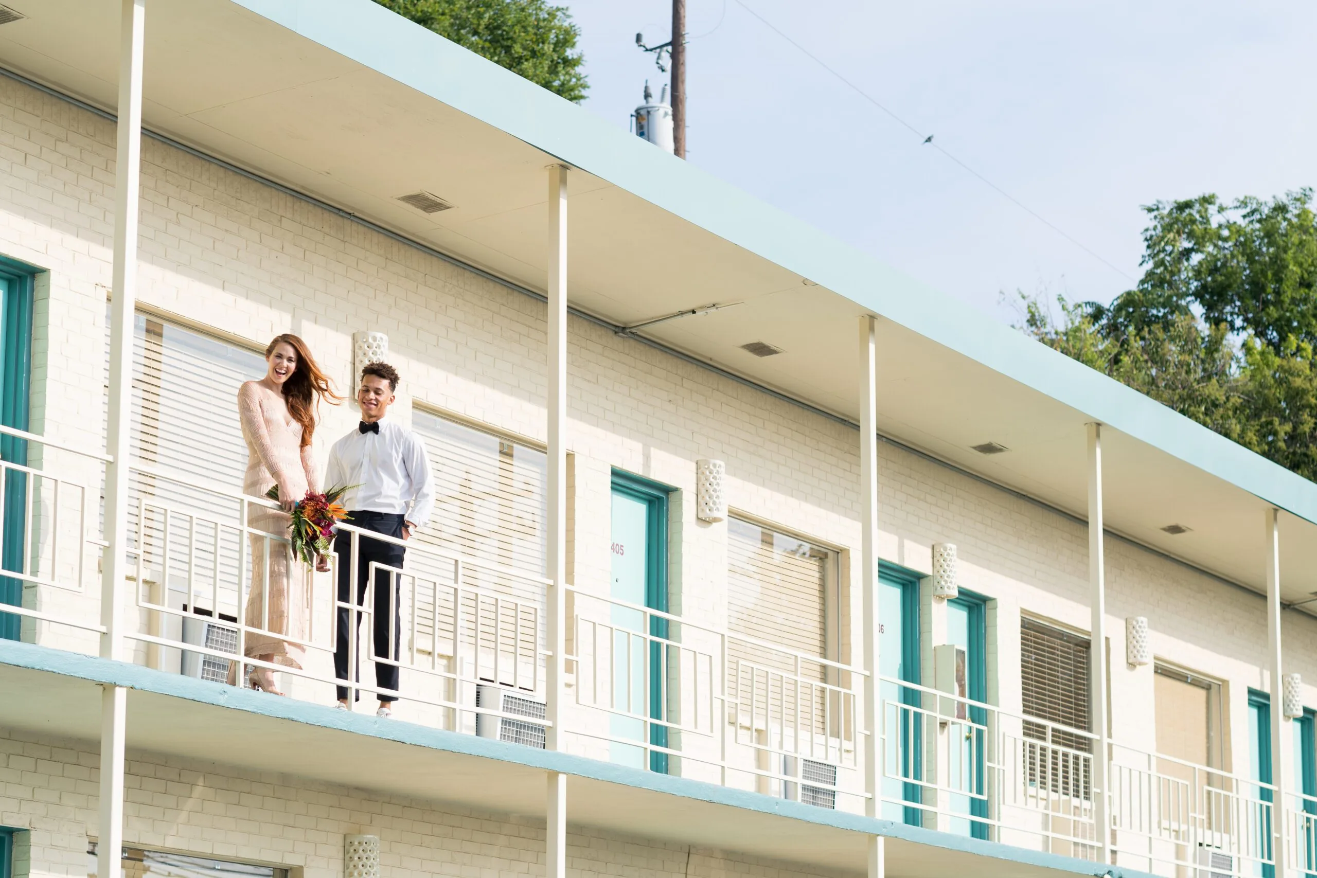 A bride and groom outside of a room at Austin Motel