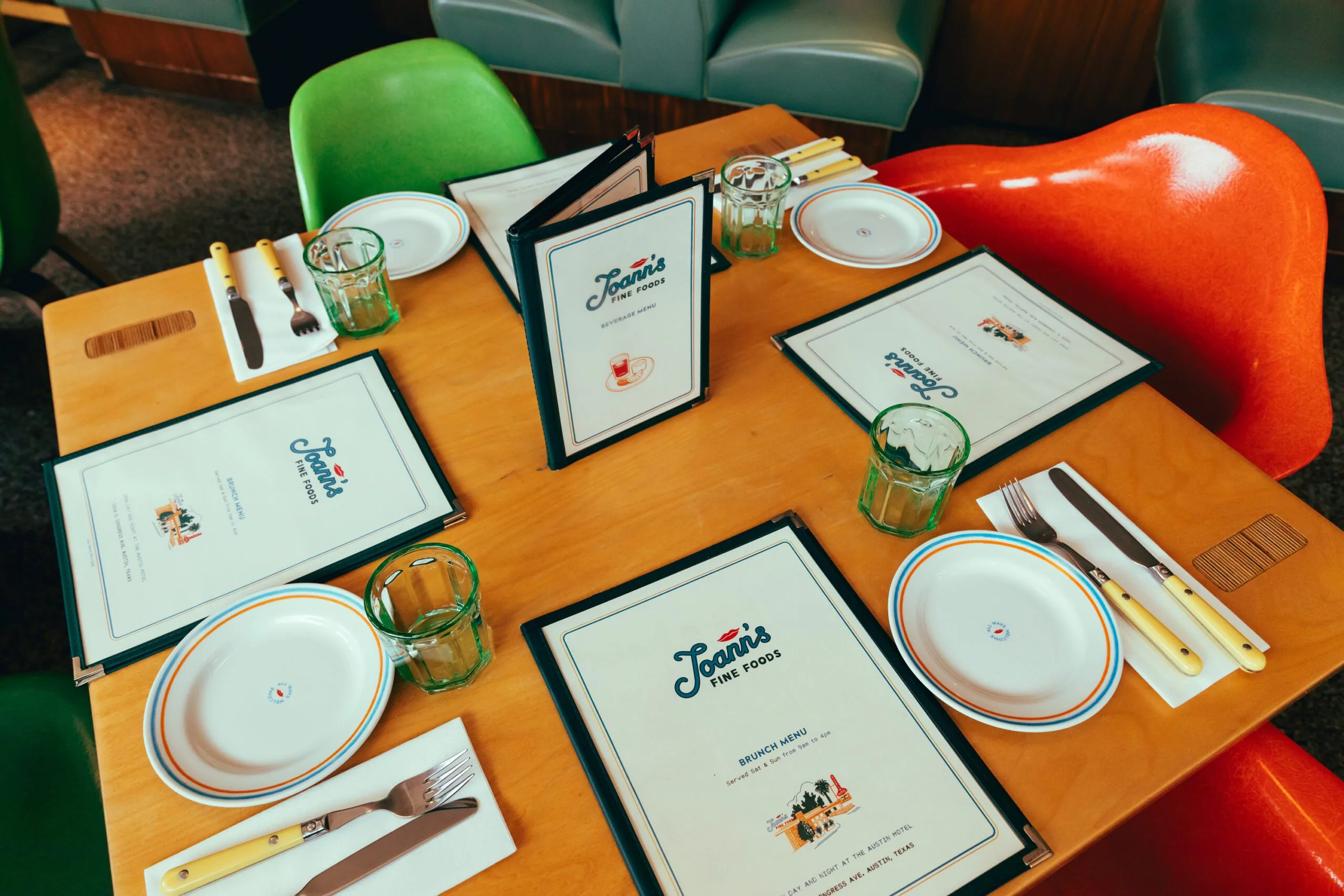 Menus, dish ware, and cutlery on a table at Joann's Fine Foods