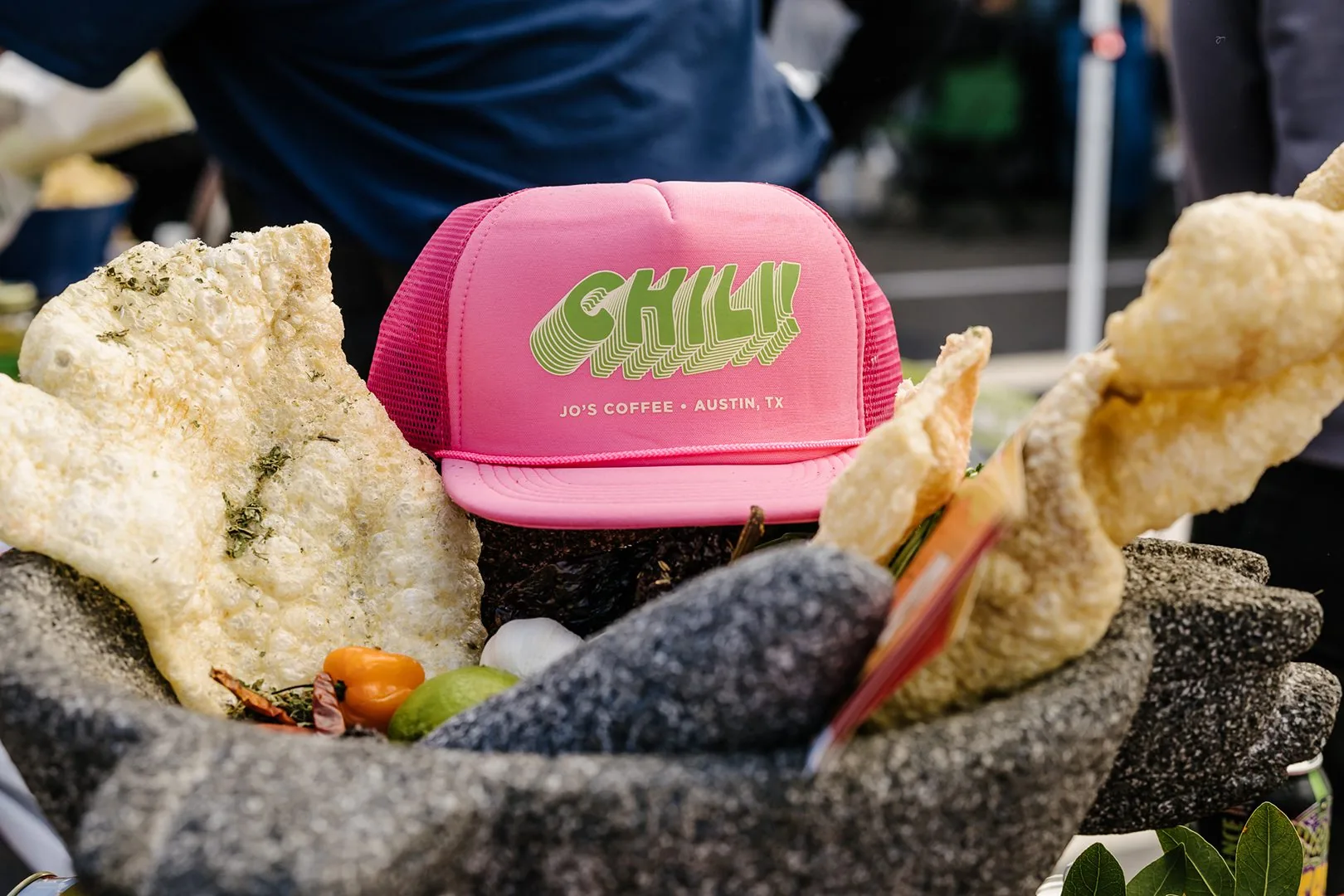 A pink trucker cap with the text "Chili" written on it.