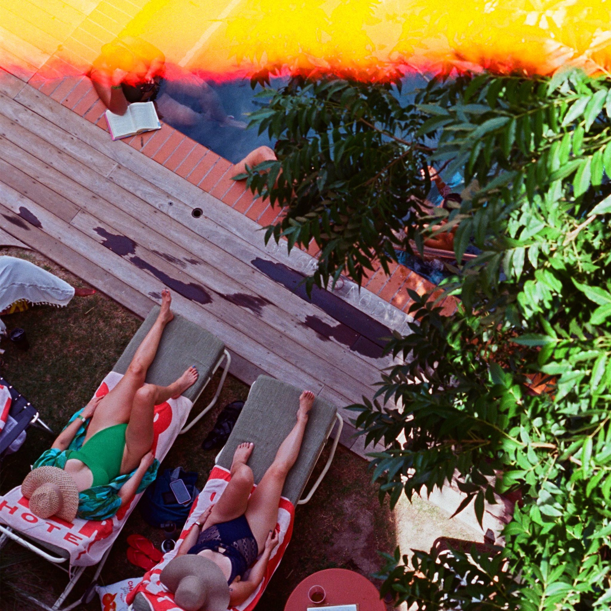 Guests laying out by the Carpenter Hotel pool