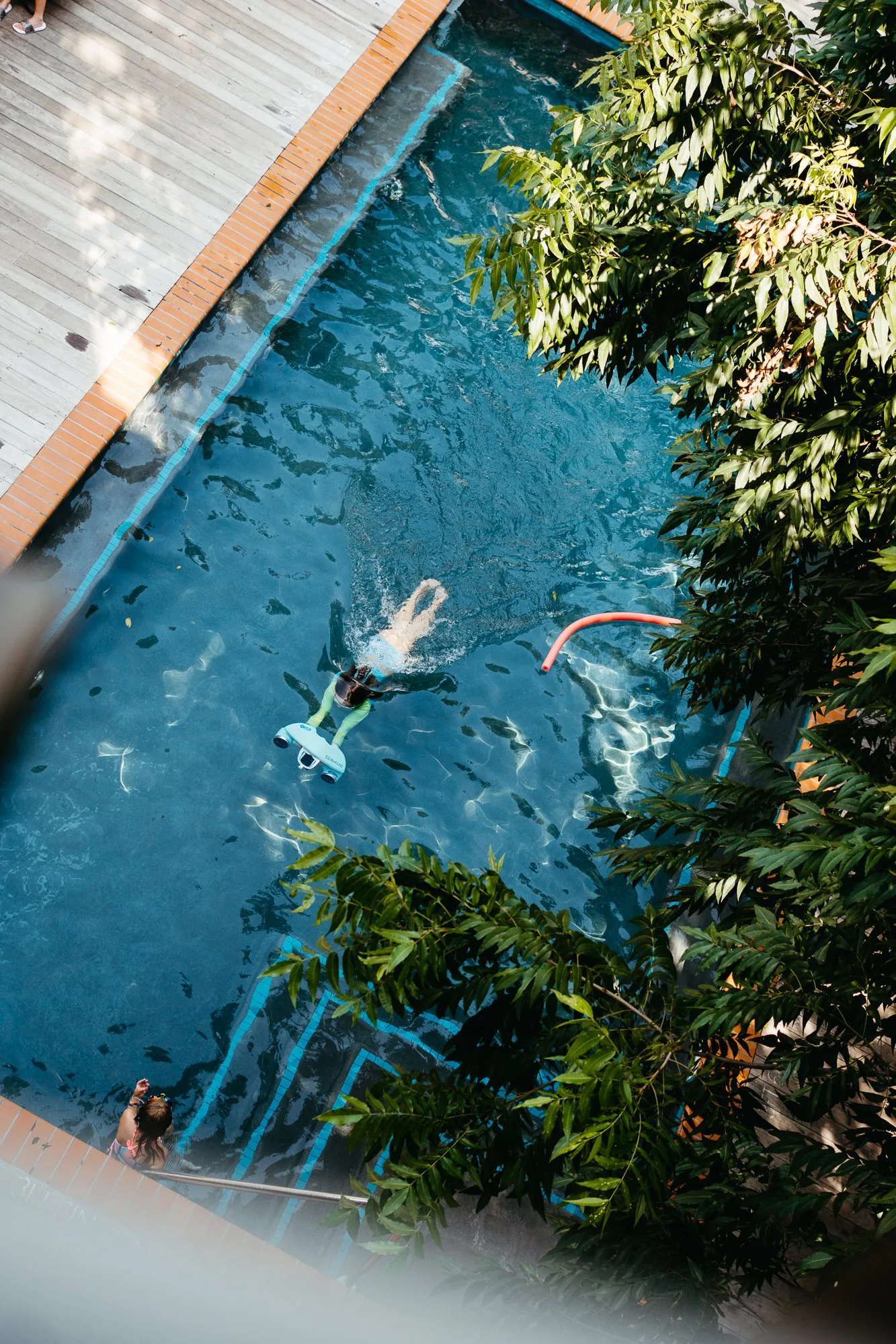 A guest swimming in the Carpenter Hotel pool