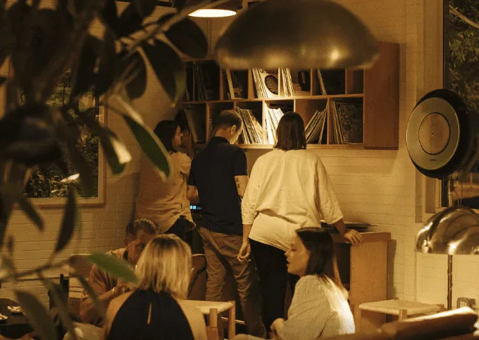 People looking at the record player at Carpenter Coffee Bar