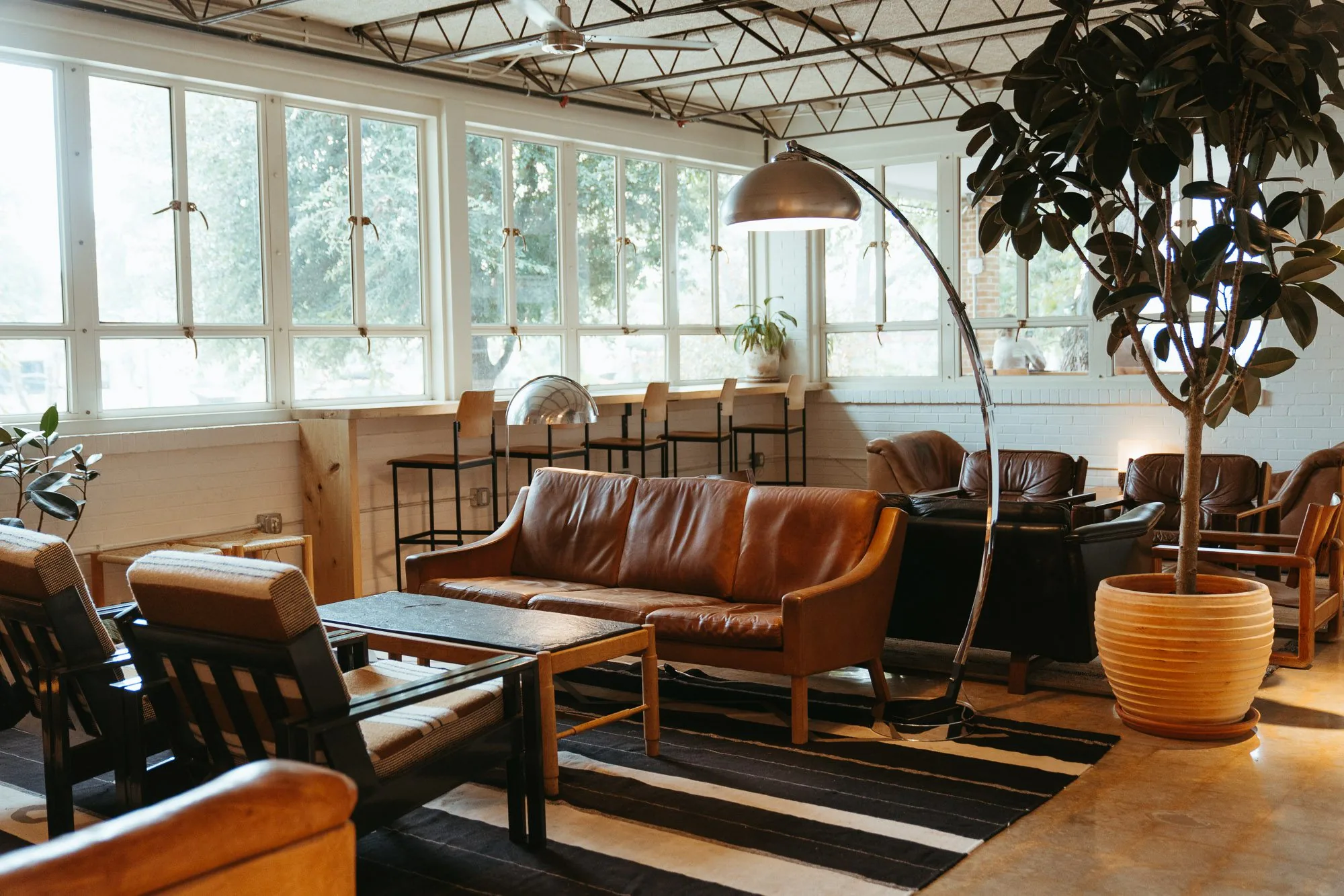 A seating area with leather couches and tables