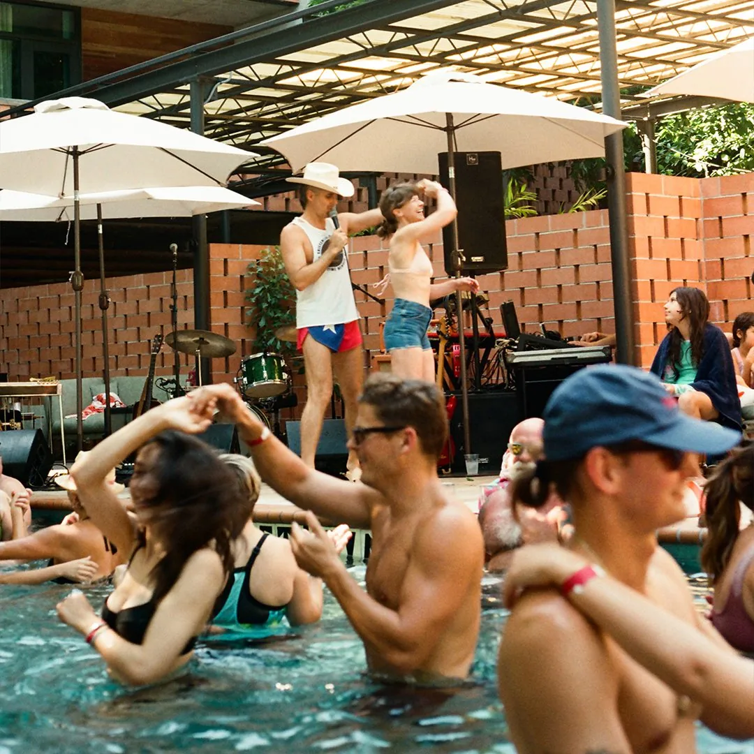 Guests enjoying the outdoor pool at the Carpenter Hotel