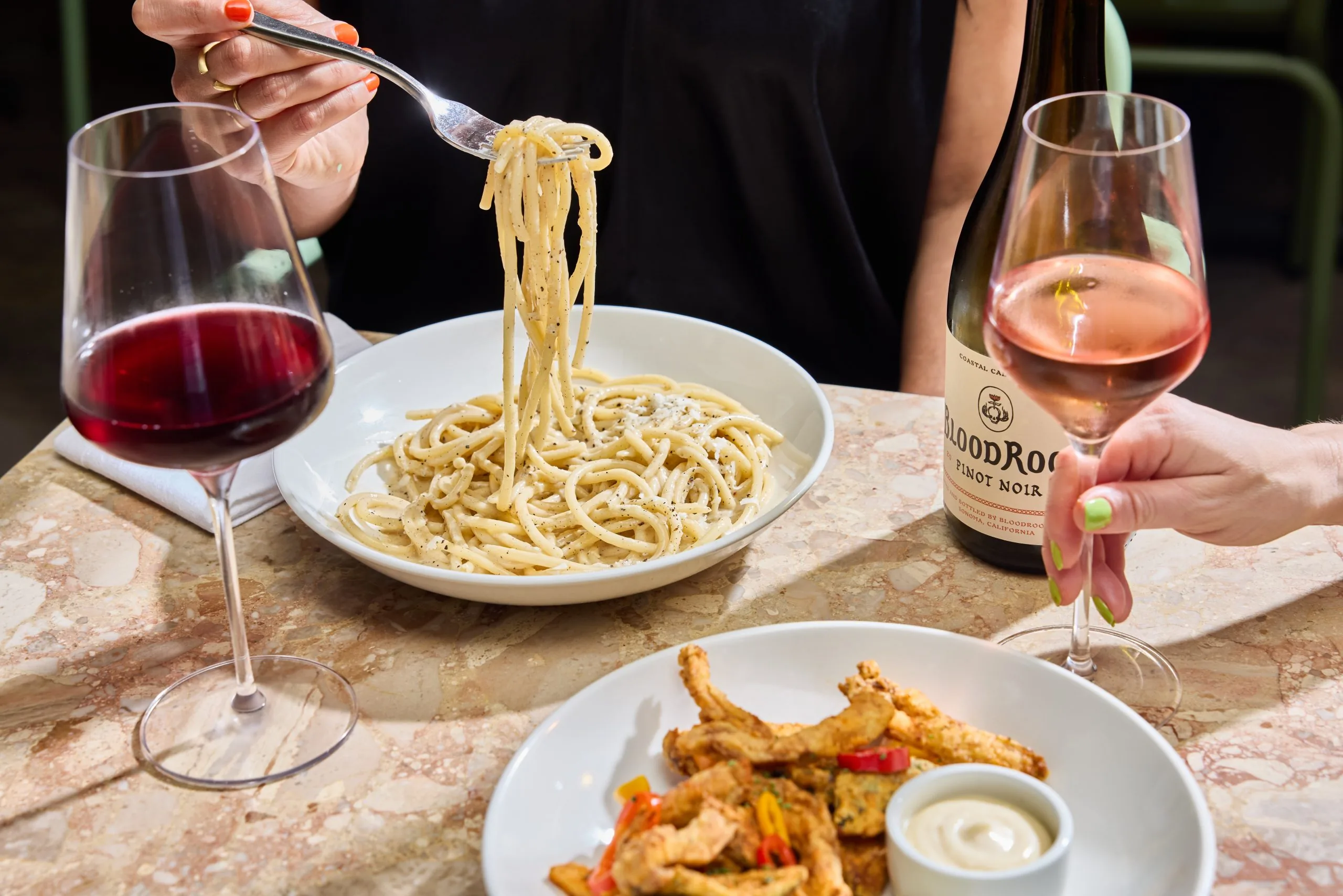 Two dinners and two glasses of wine on a table