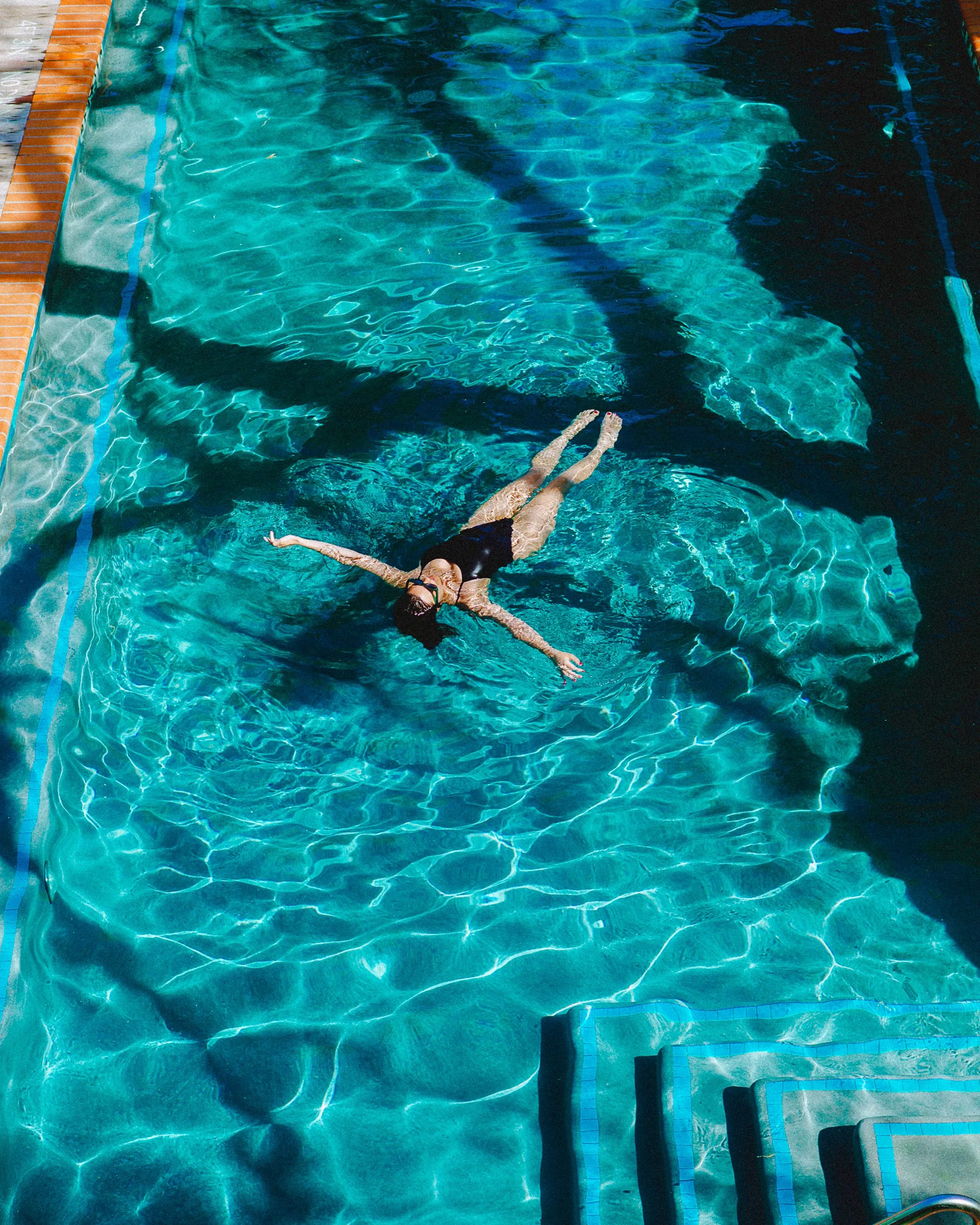 Girl floating in pool