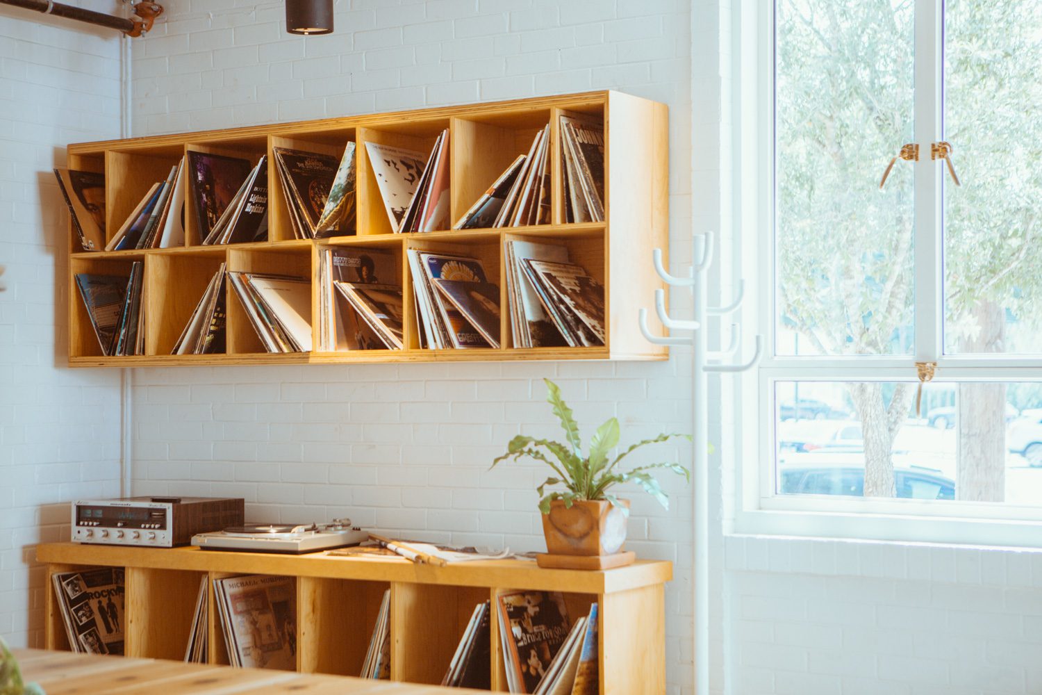 Shelves of records and a record player in the Carpenter Hotel lobby