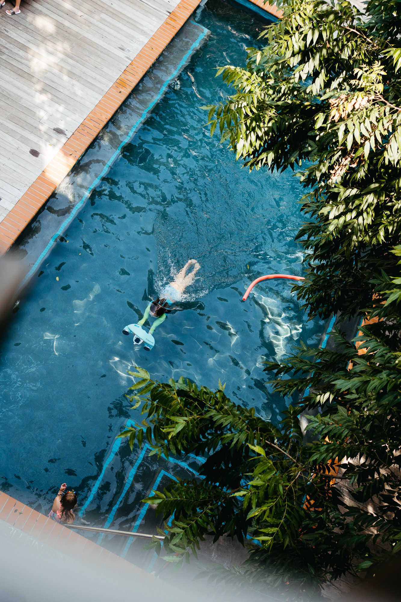 A guest swimming in the Carpenter Hotel pool