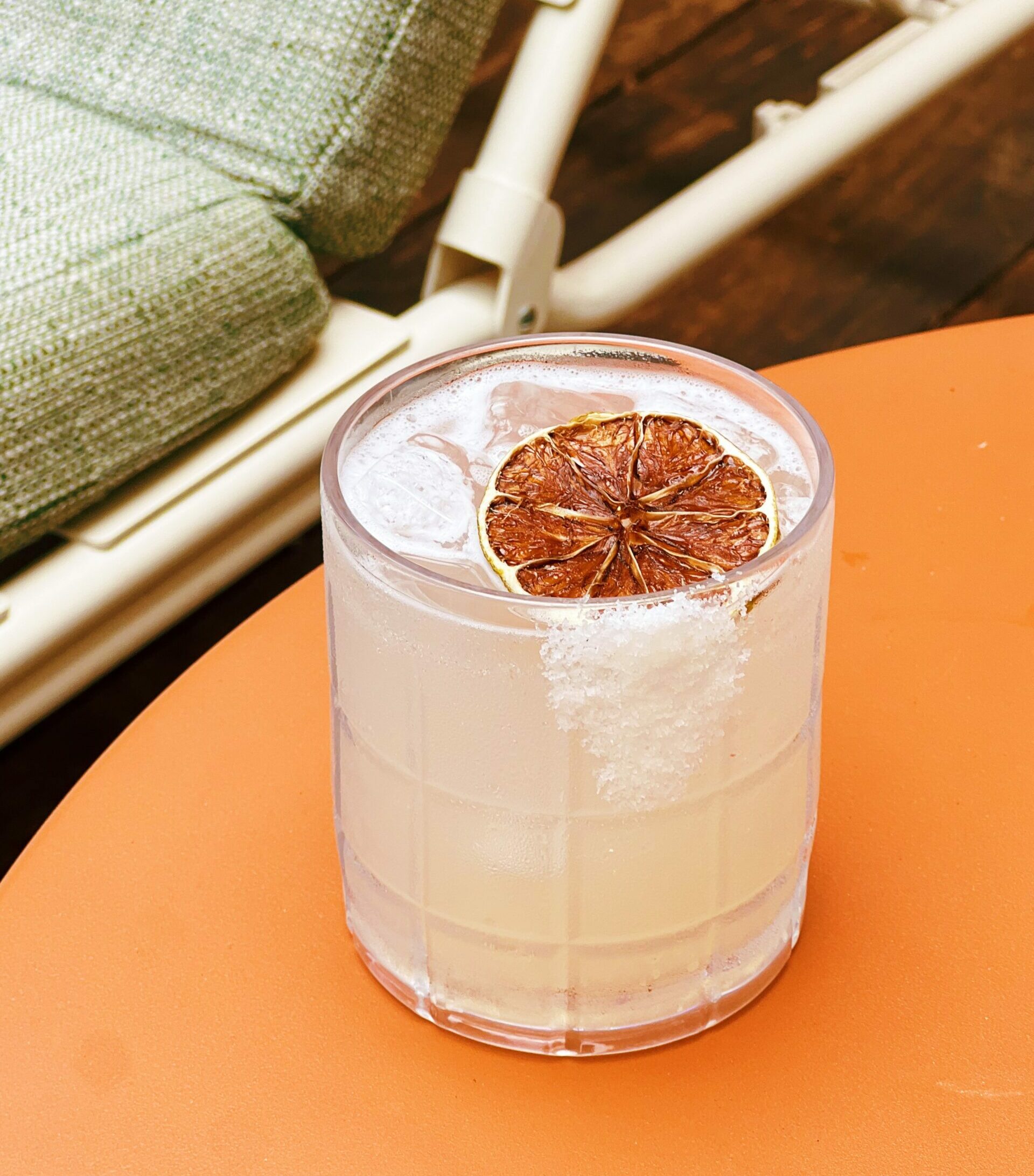 A cocktail on an orange table