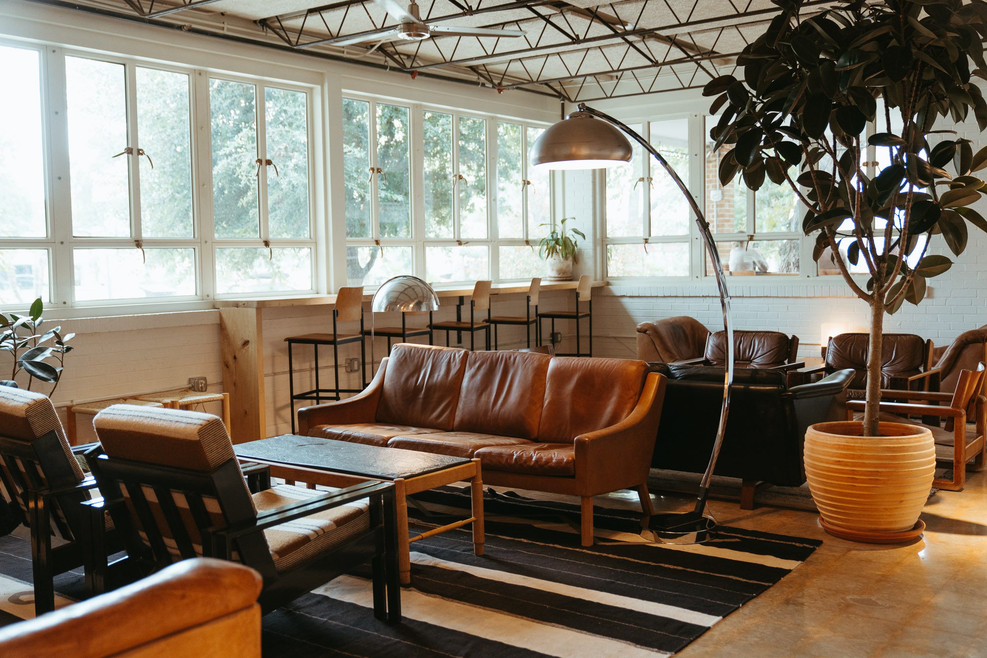 A seating area with leather couches and tables