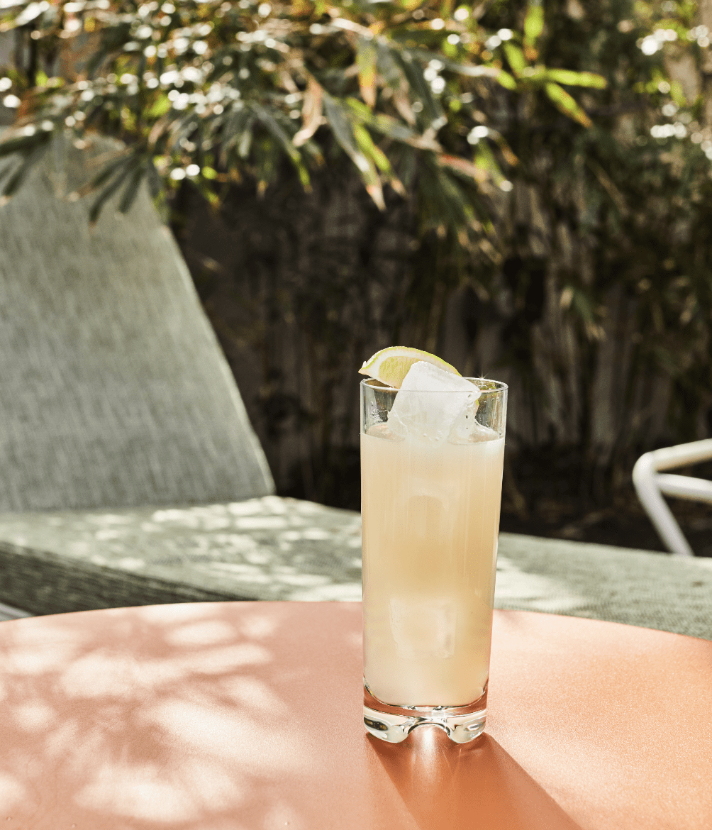 A tall cocktail on a table outside