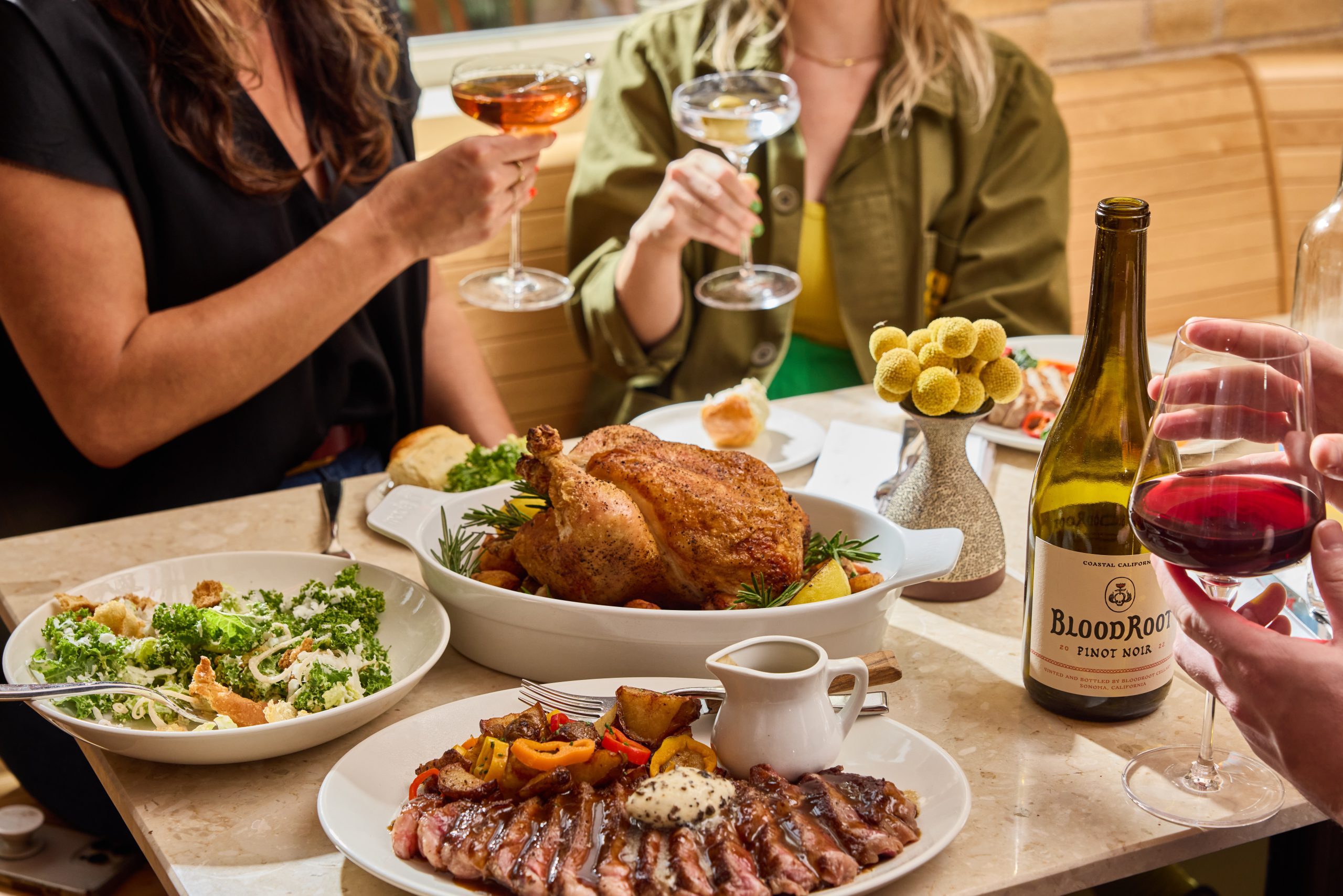 A selection of dinner plates and people raising their glasses
