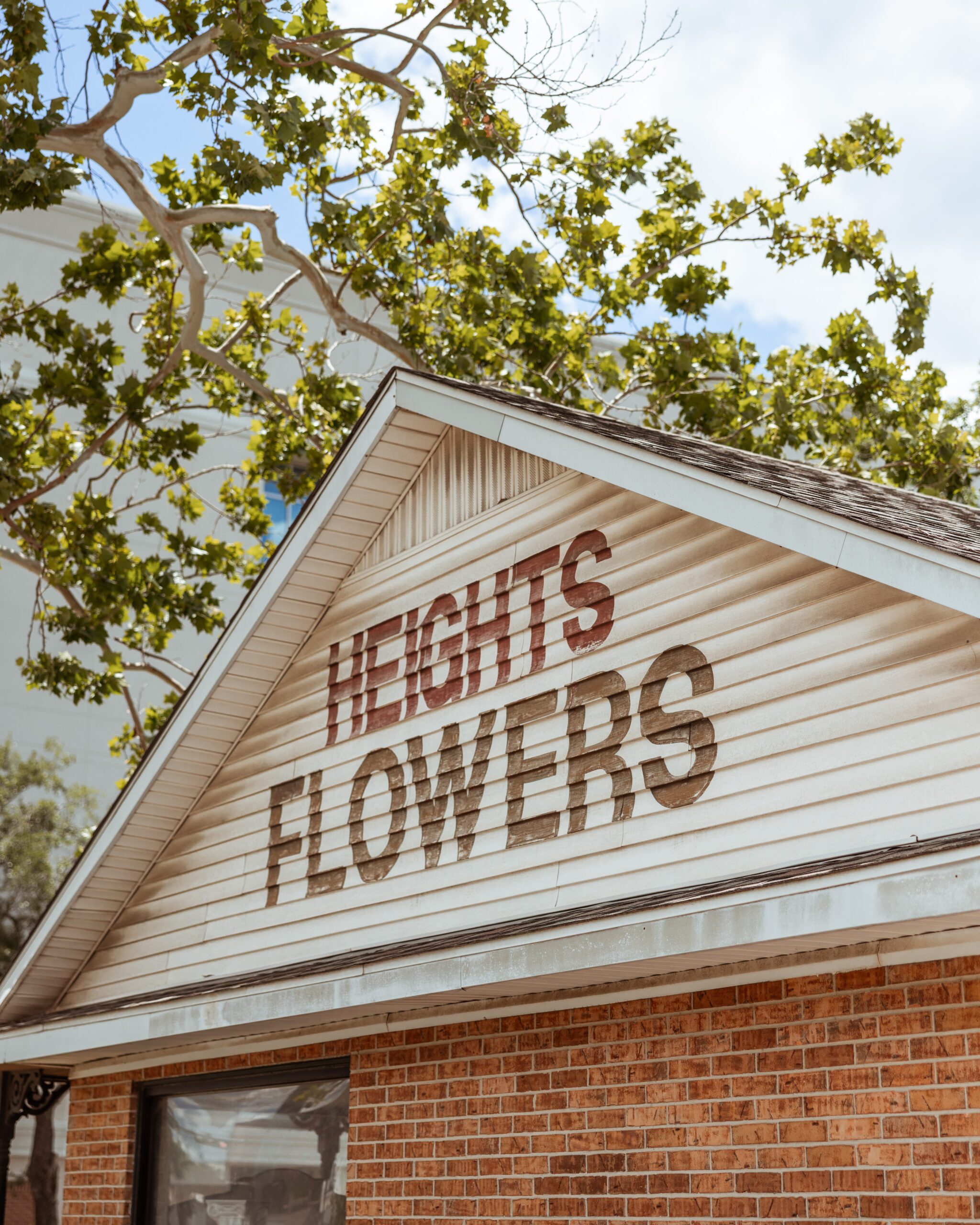 Side of building handpainted with Heights Flowers