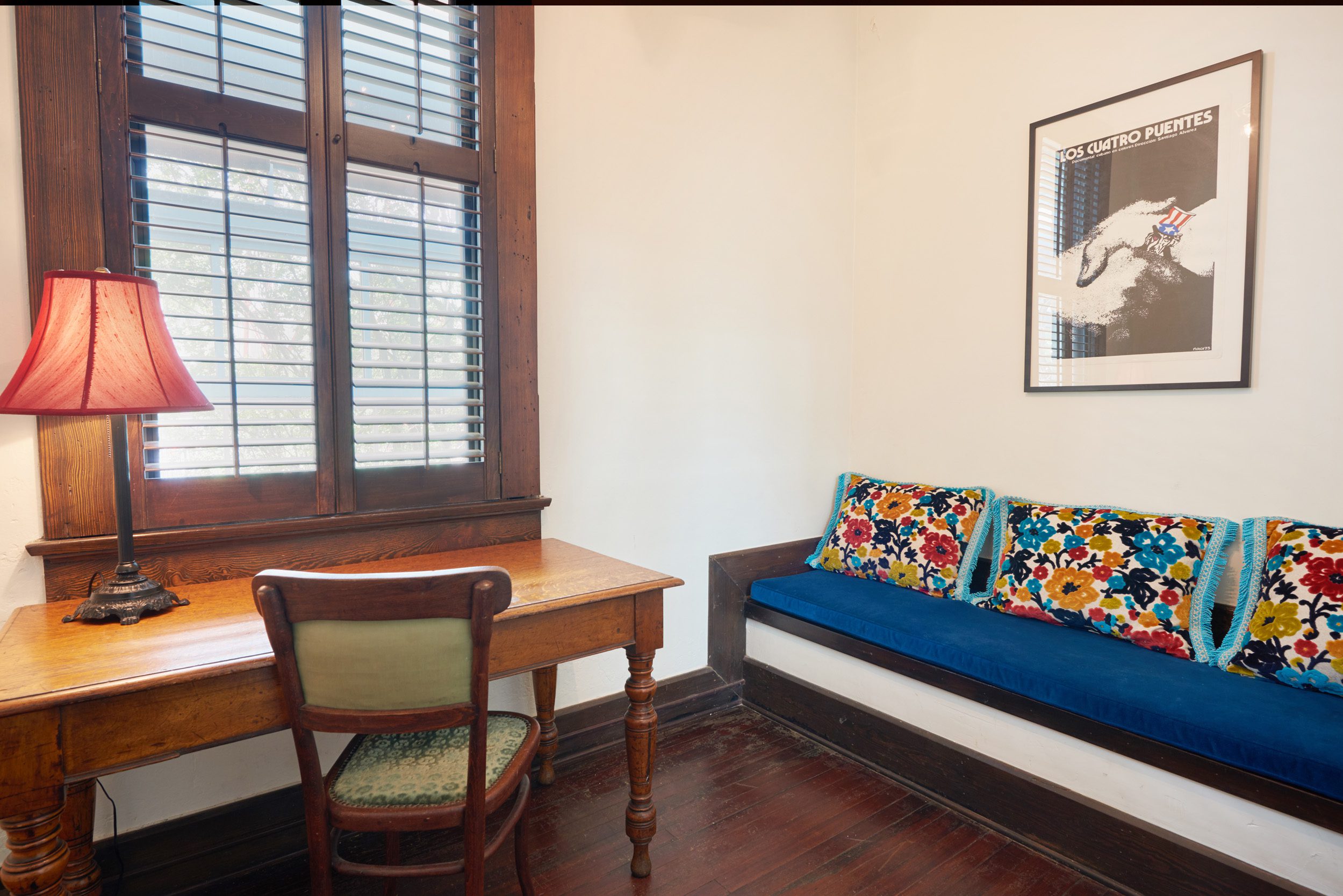 Built in banquette with pillows next to a wooden desk