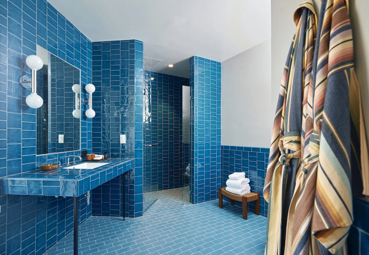 A blue yellow subway tiled bathroom