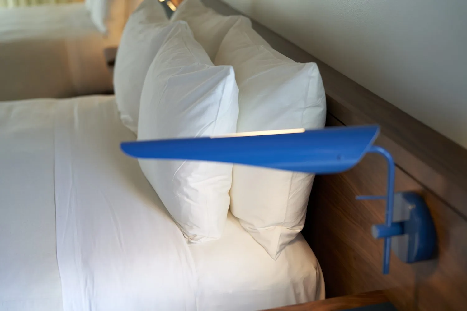 A unique light next to a bed in a Music Lane Queen room at Hotel Magdalena