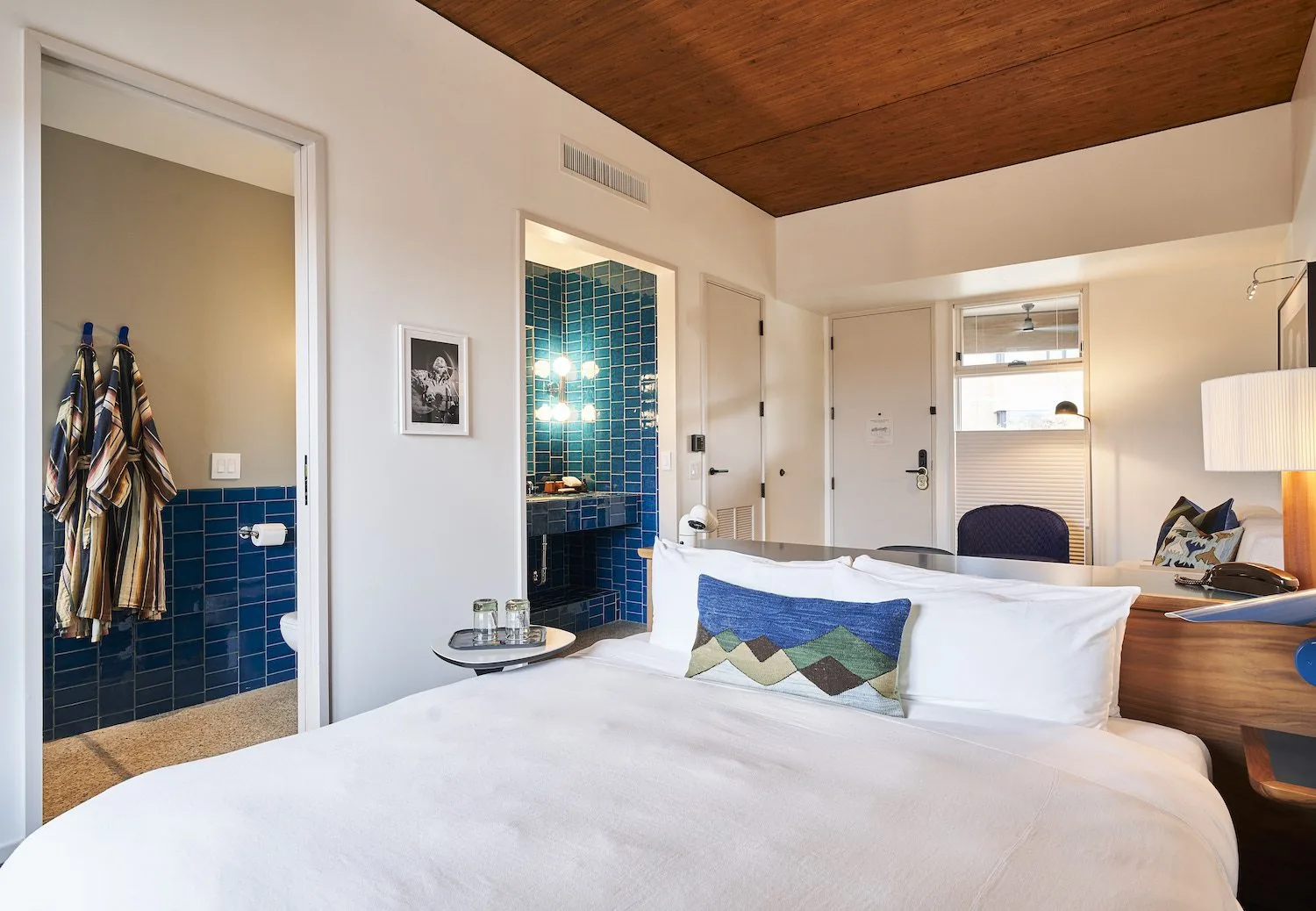 A Treehouse Studio room with a king bed and blue subway tiled bathroom