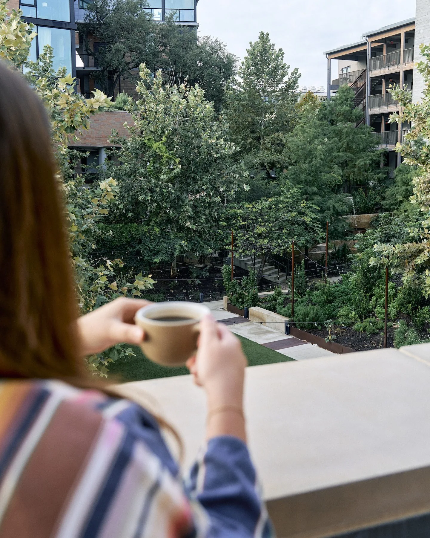 person holding coffee on terrace