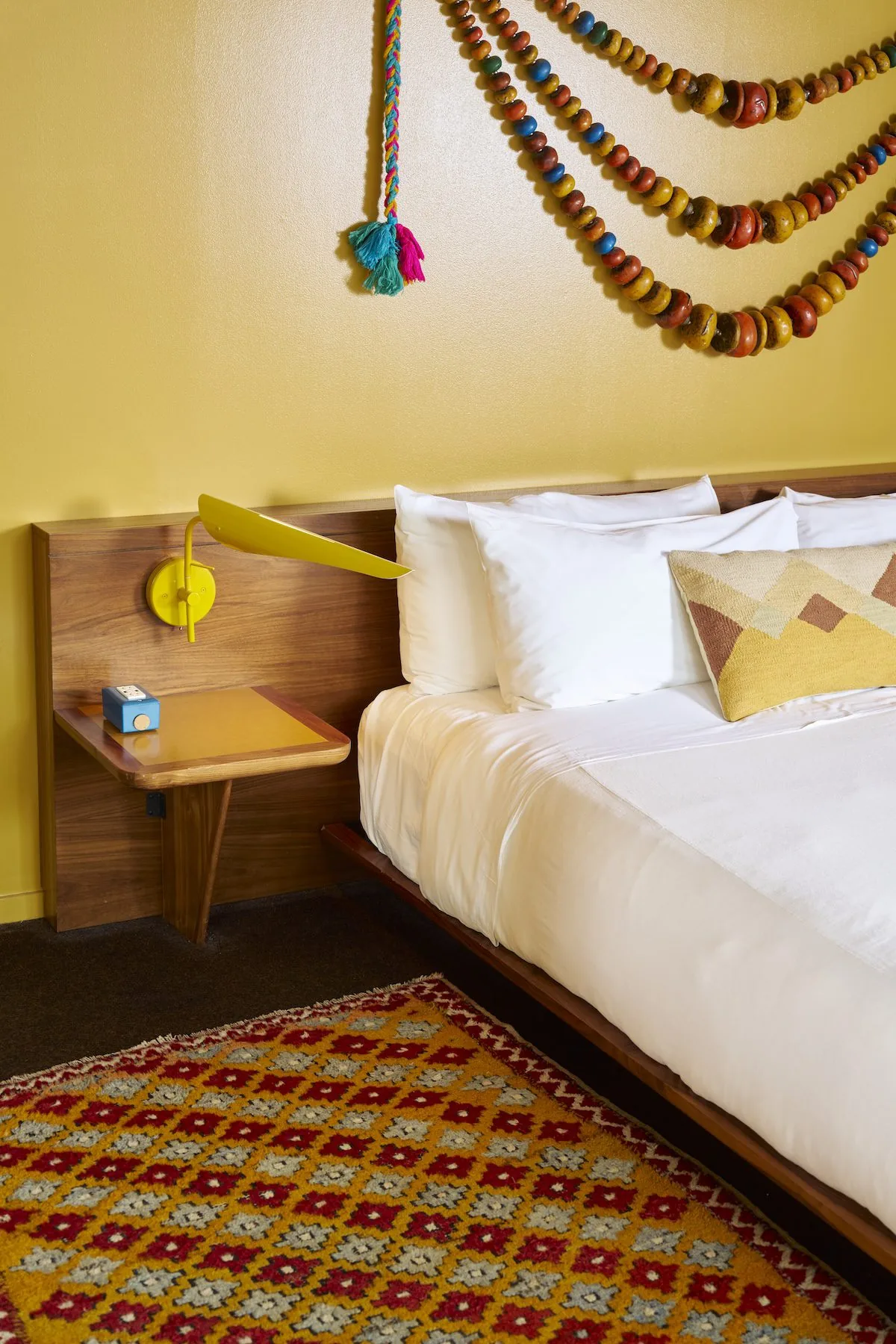 Terrace Suite bedroom with yellow accents