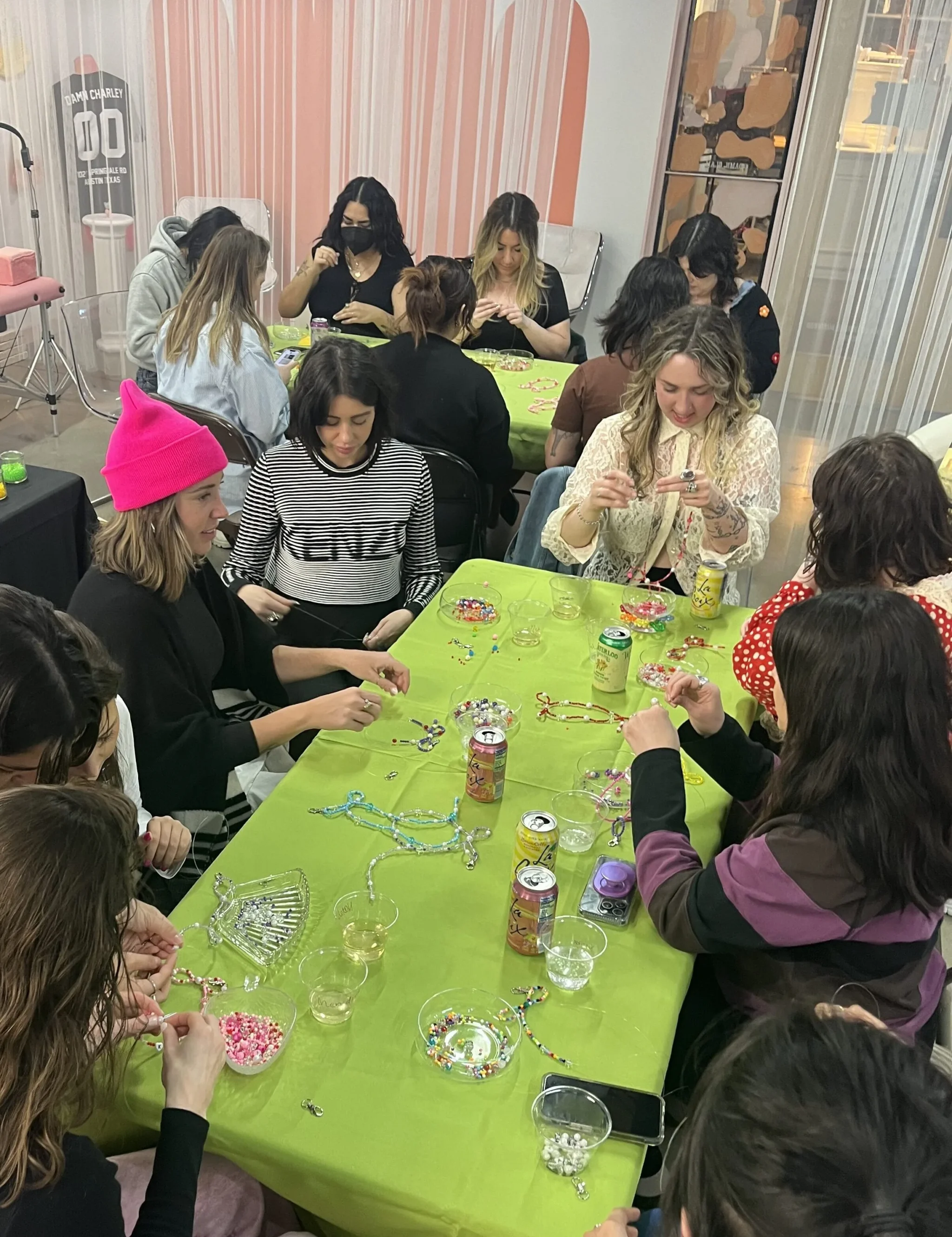 girls at a table making beaded bracelets