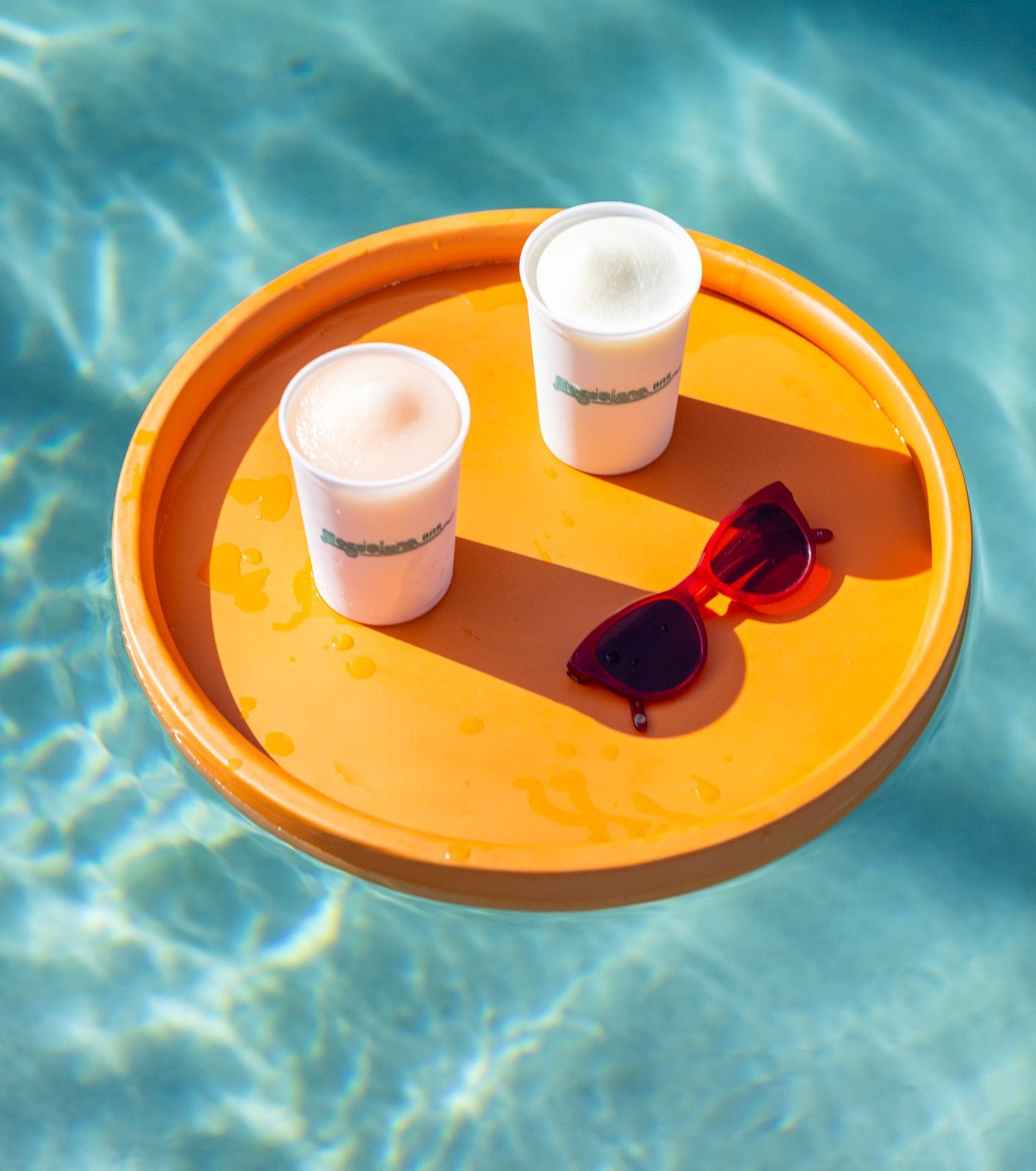 frozen cocktails floating on a tray in water