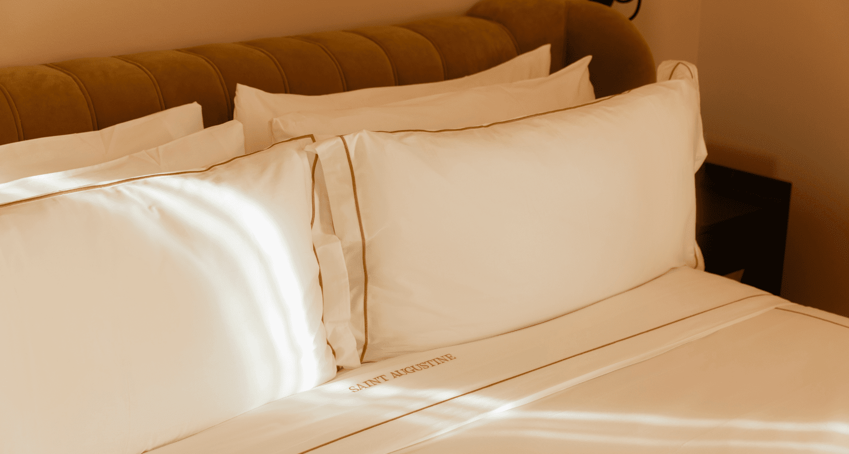 Tight shot of bed with upholstered headboard