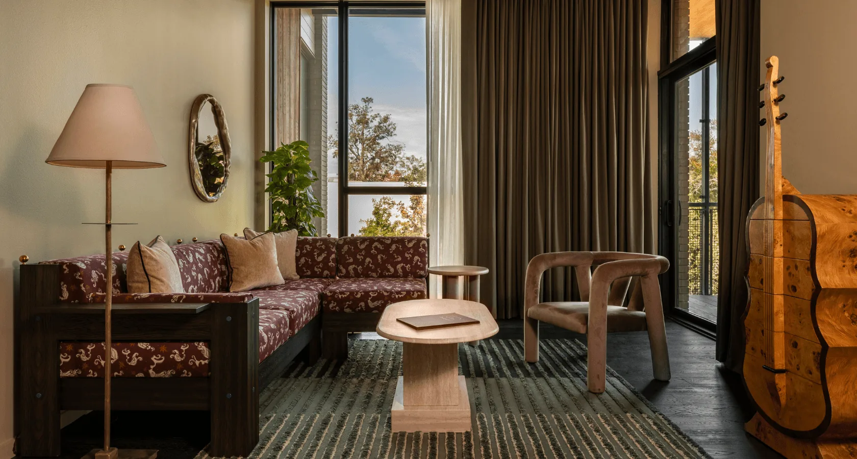 interior with couch, tables, and dresser shaped like a cello