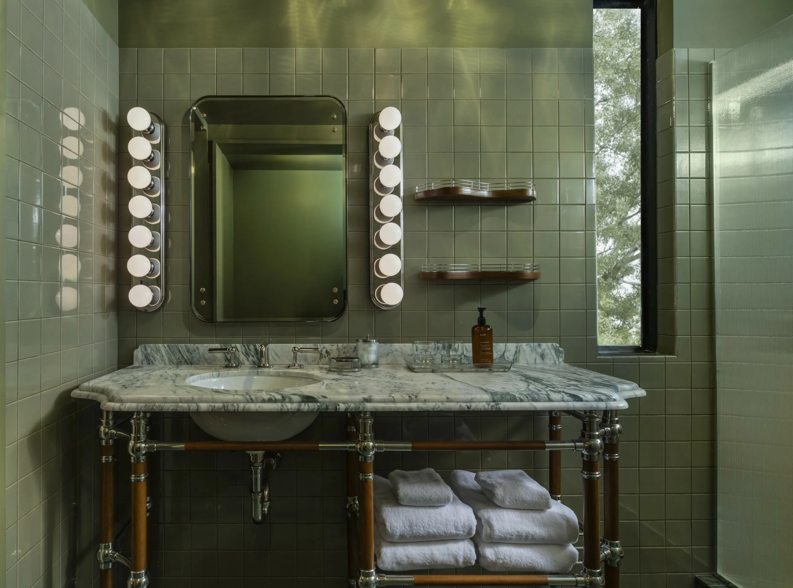 Green tiled bathroom with marble vanity