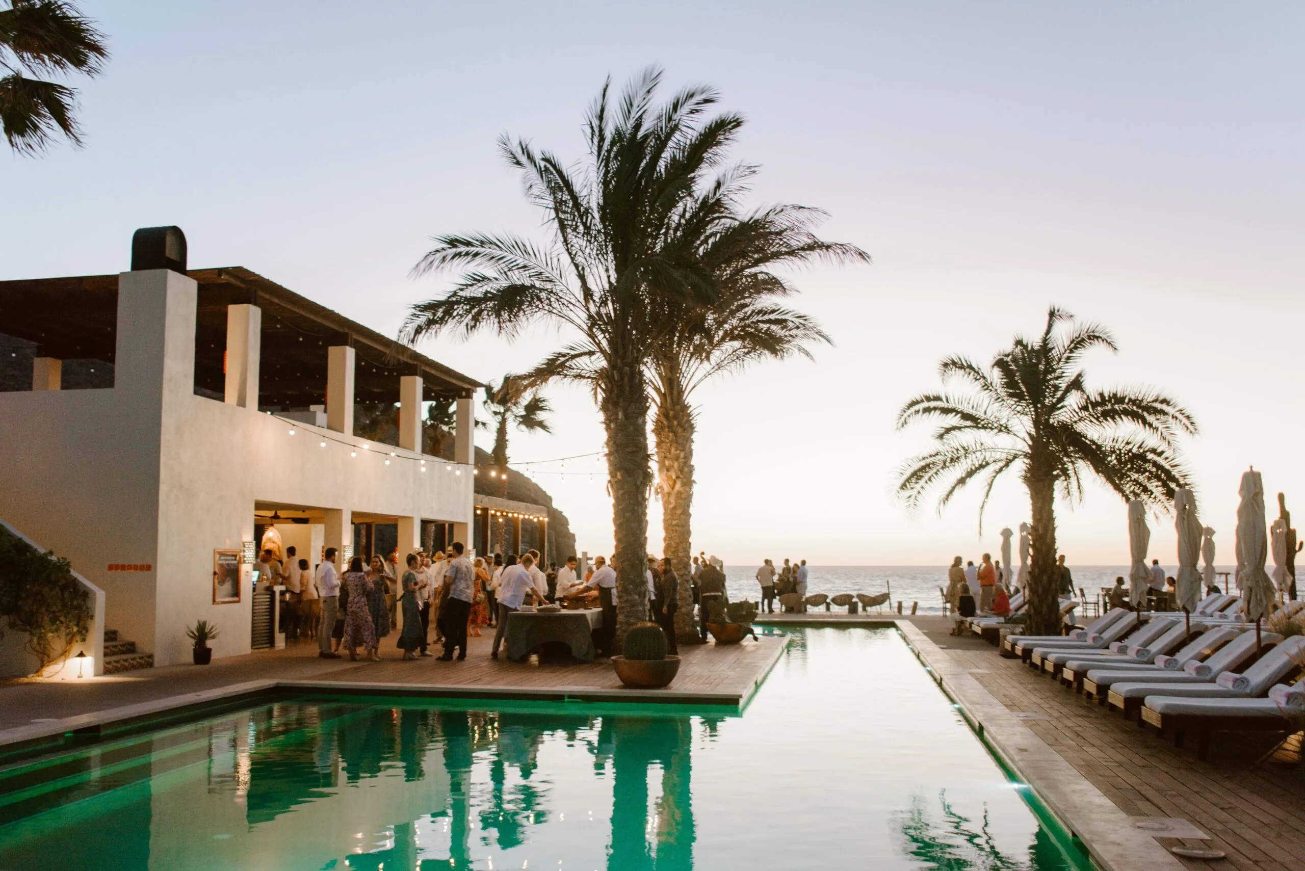 Wedding guests gathered outside next to the pool