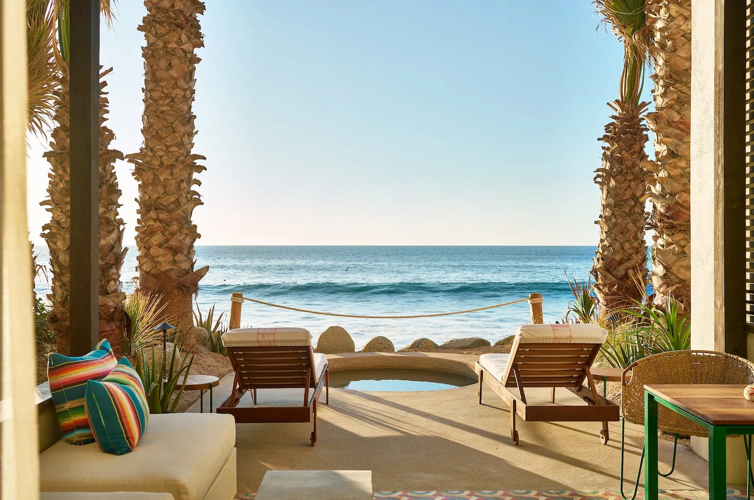 plunge pool with loungers overlooking beach