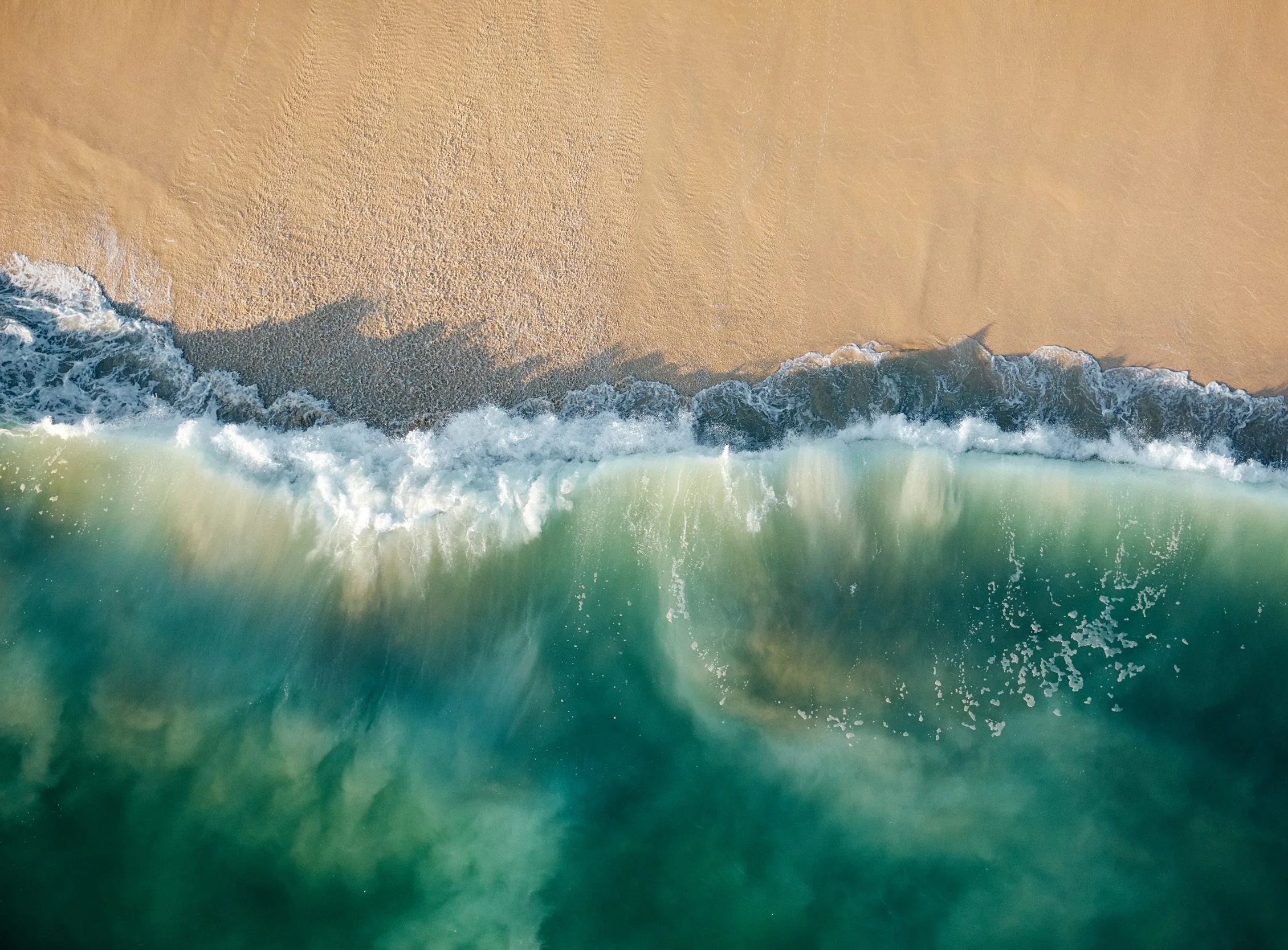 overhead landscape of ocean and sand