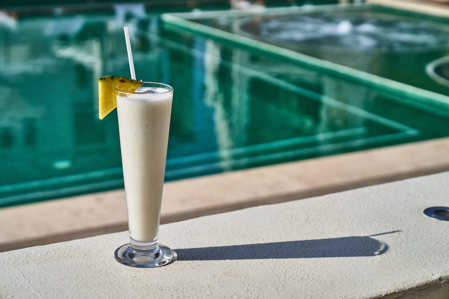 Pina colada cocktail by pool