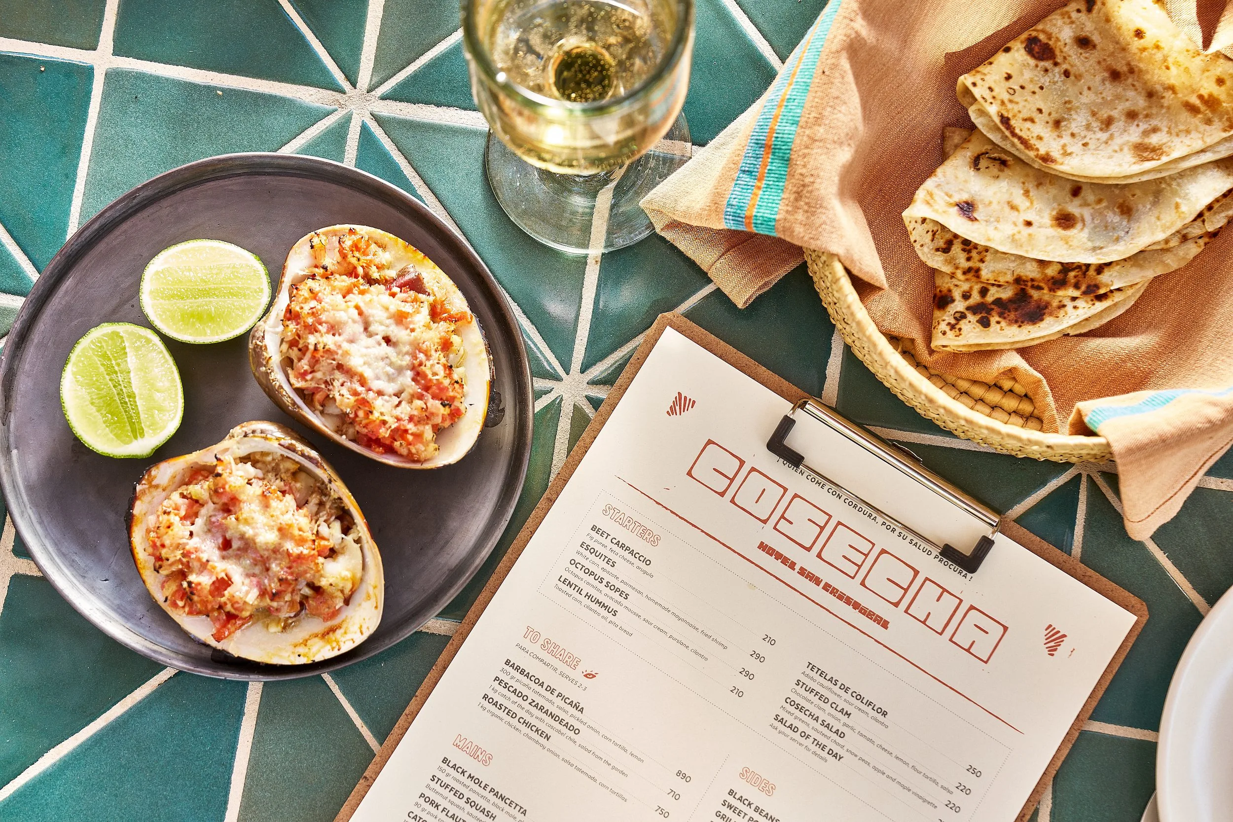 food on a table with tortillas and the printed menu