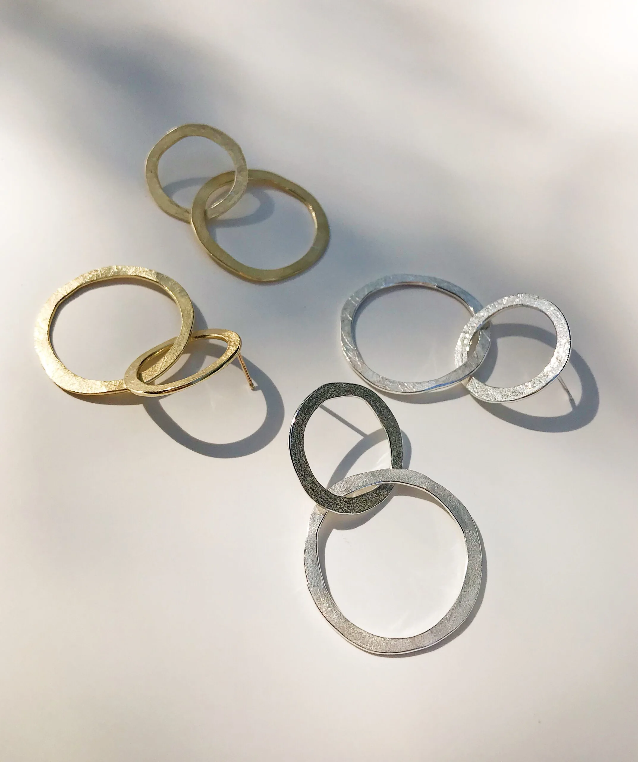 silver and gold looking jewelry on a table
