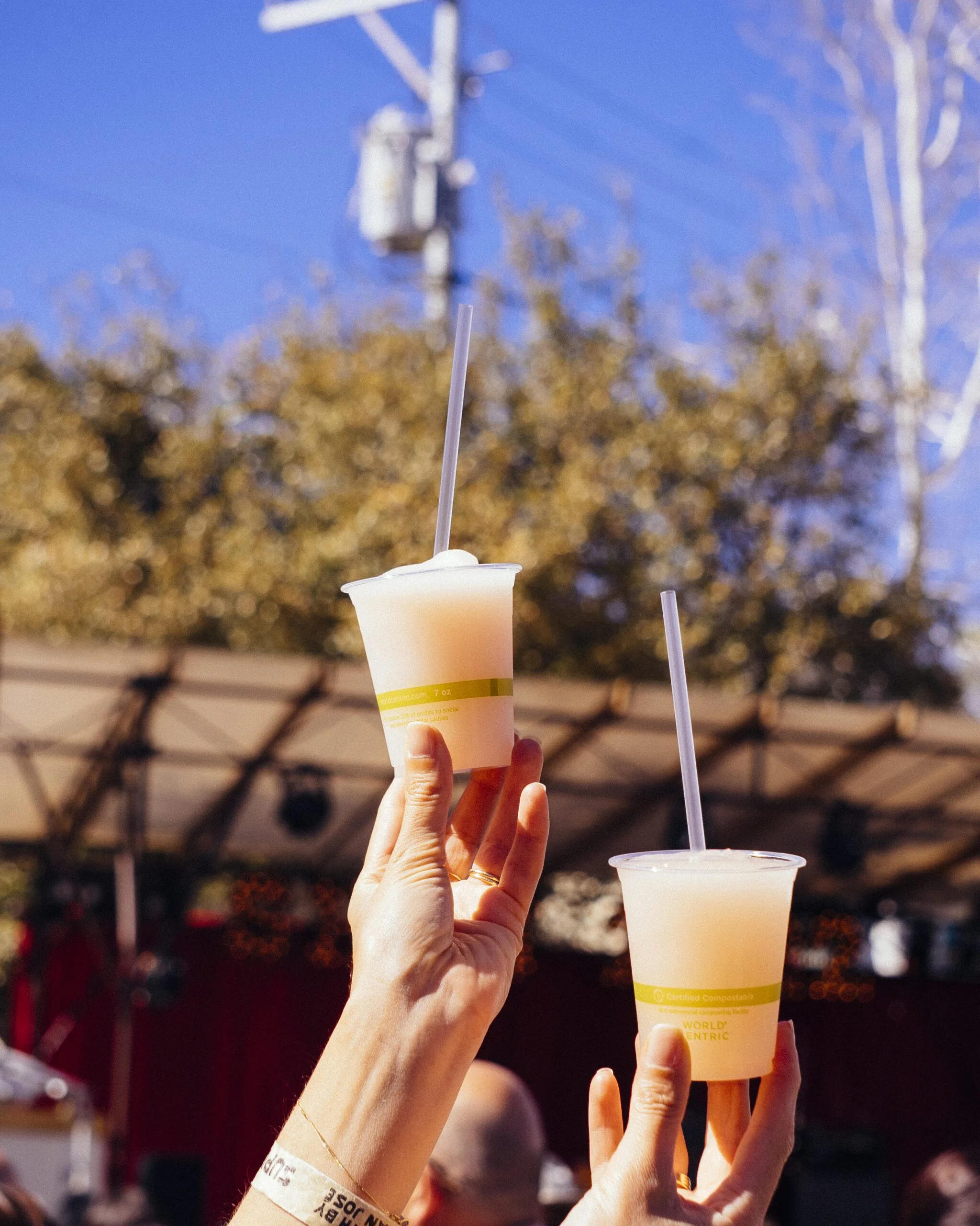 Two hands holding up iced drinks