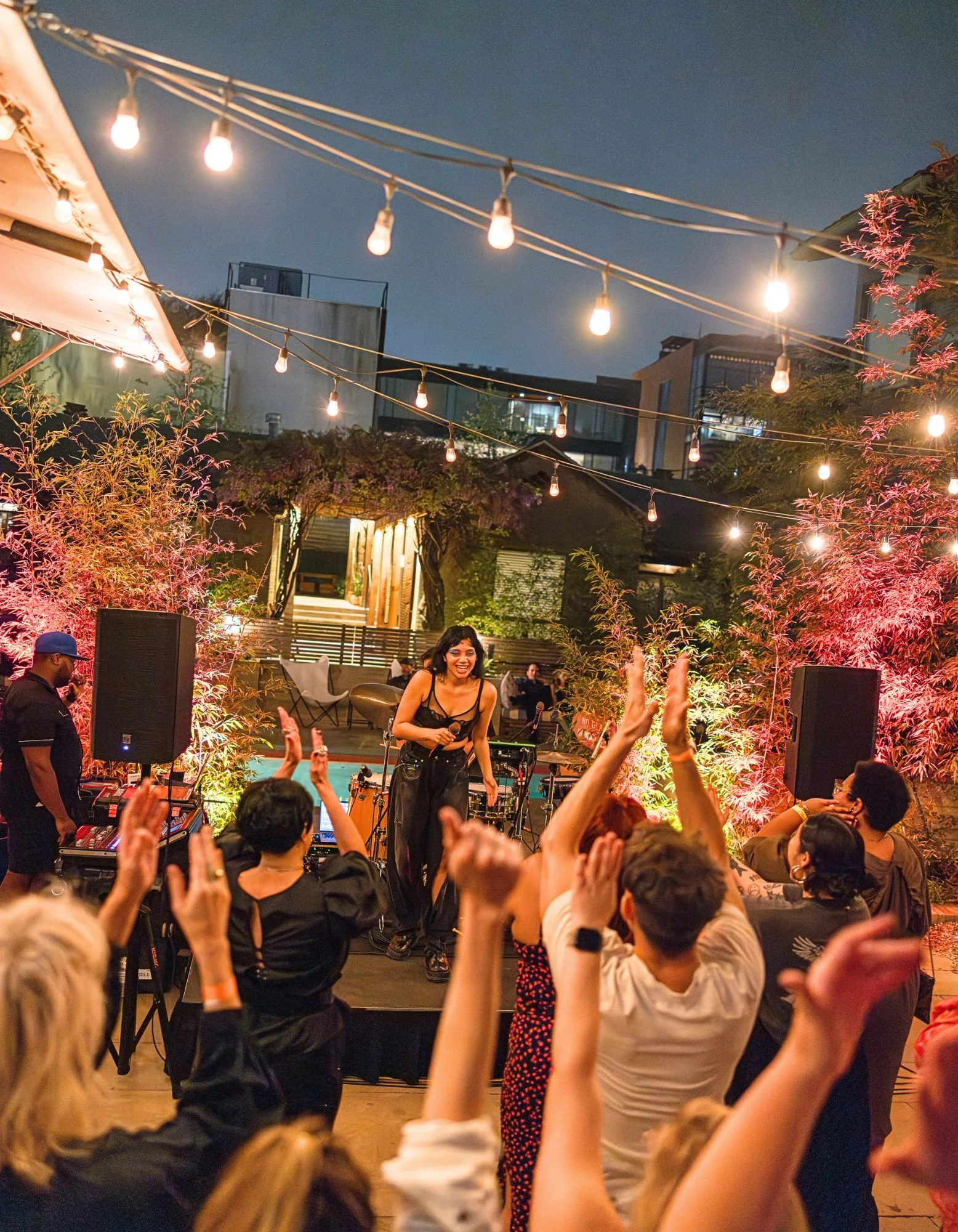 outdoor performance by a woman and people clapping