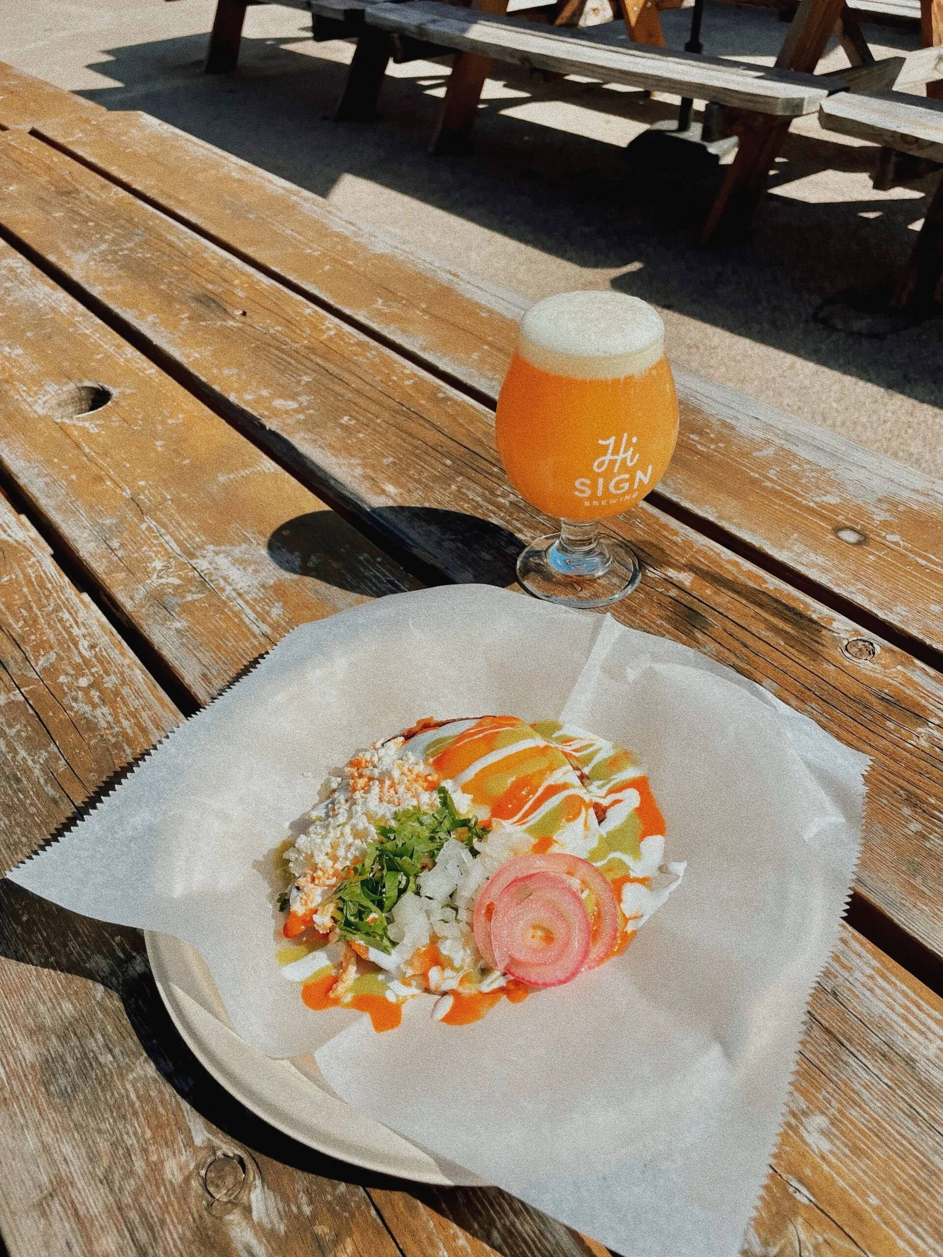 food and drink on a outdoor picnic bench