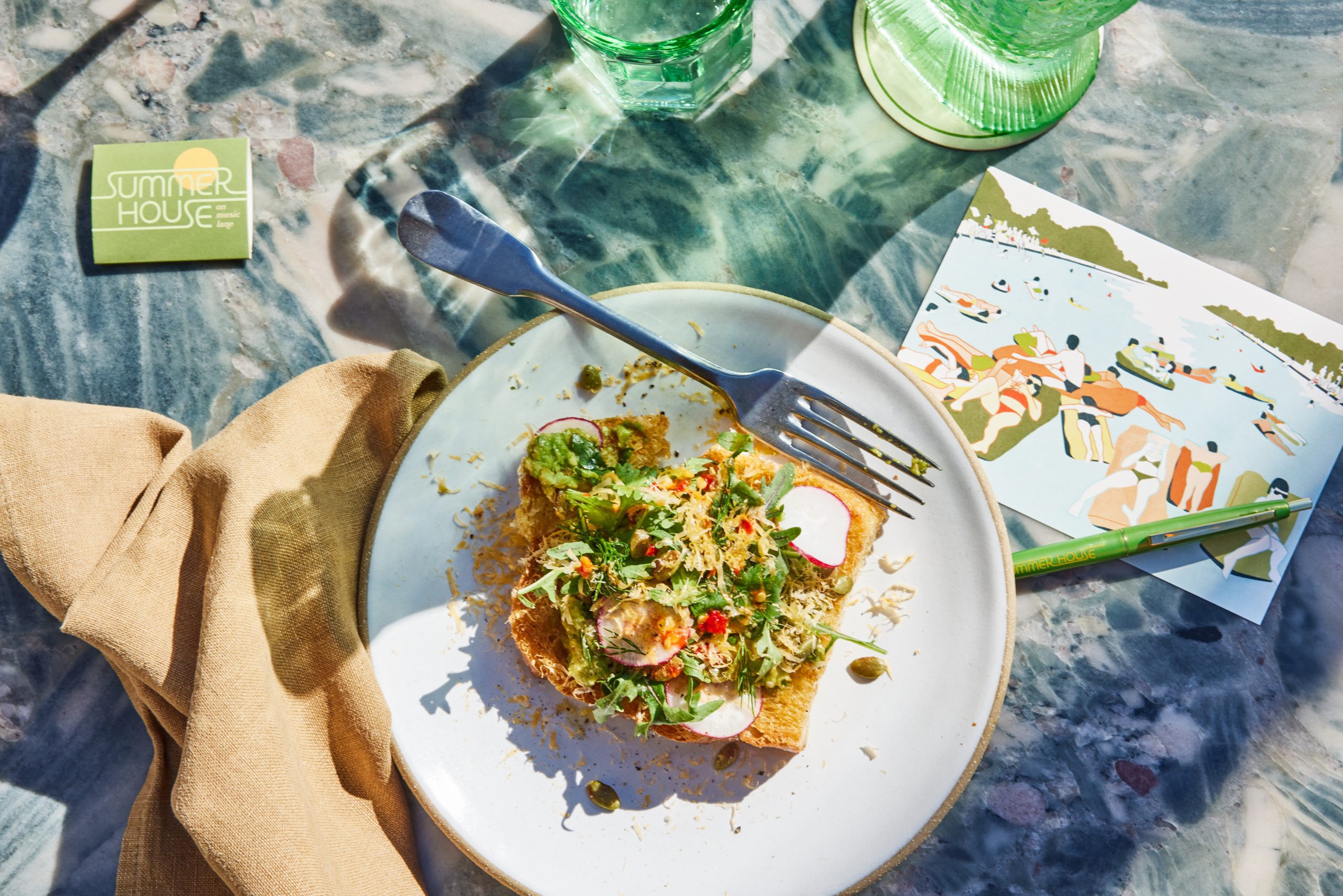 AVOCADO TOAST with house focaccia, tomatillo, toasted pepitas, mimolette cheese