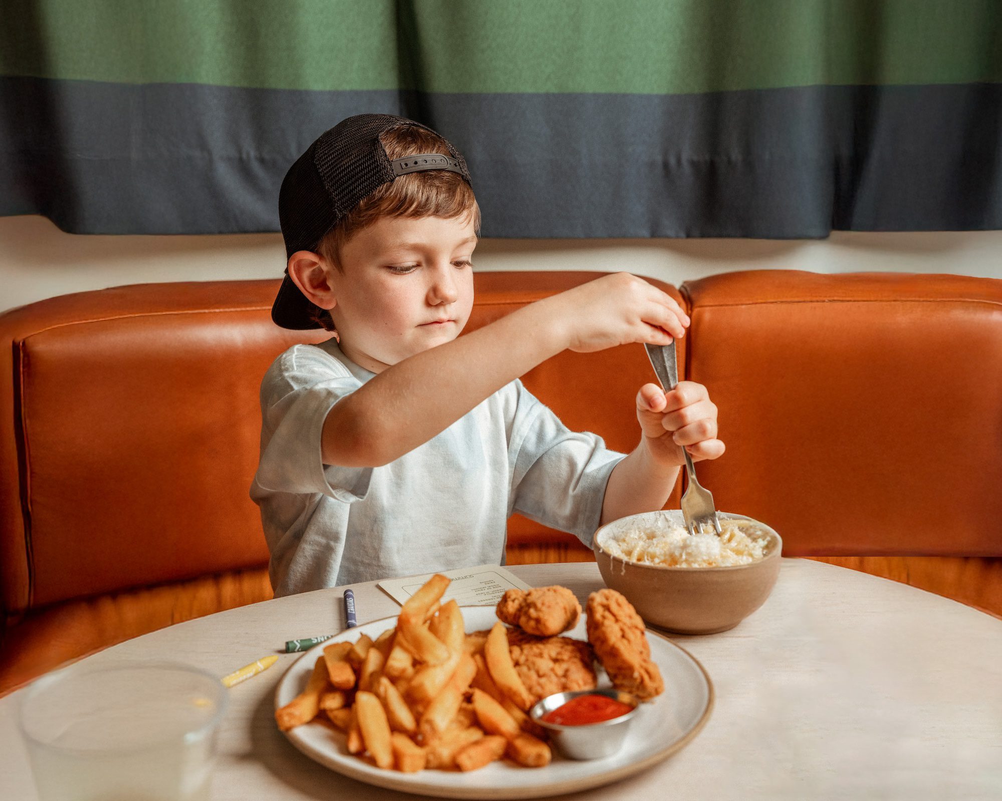 kid spinning noodles on a fork