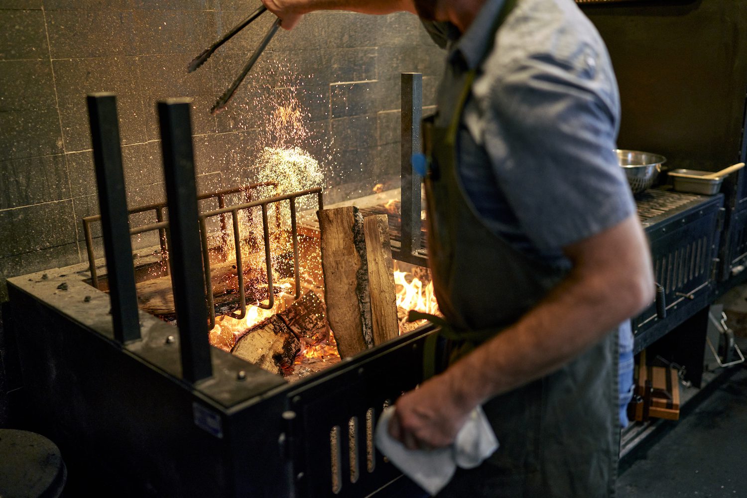 Chef using the live fire grill
