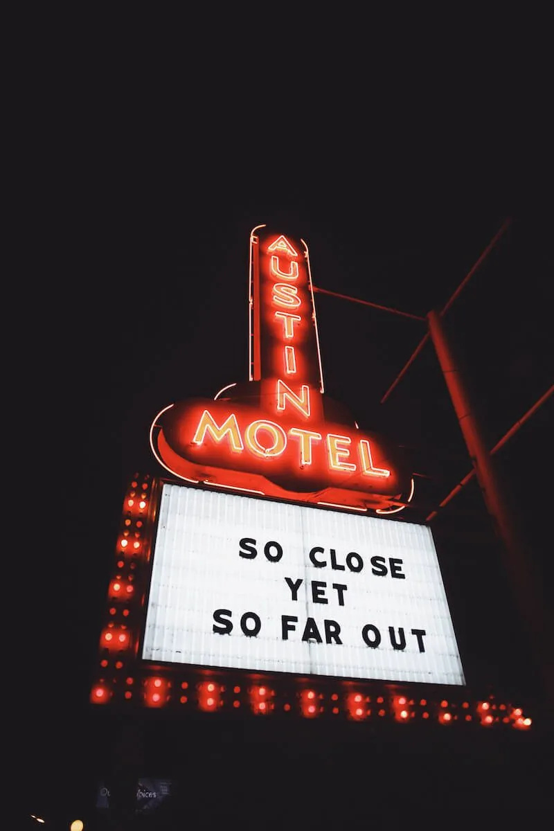 Austin Motel Marquee with the phrase "so close yet so far out"