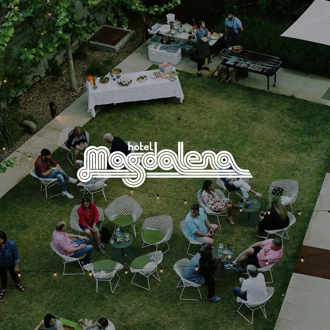 Hotel Magdalena Logo over people on the lawn