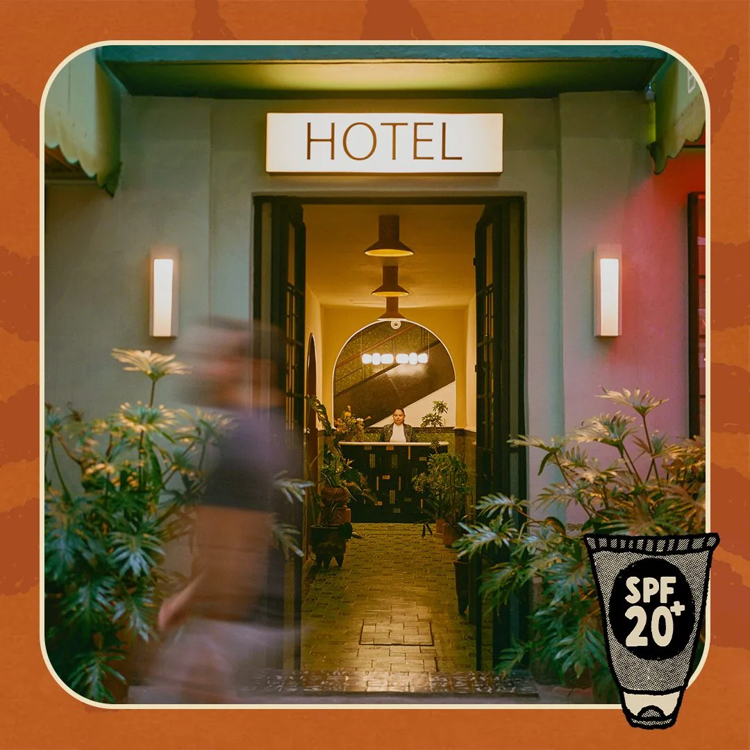 Hotel San Fernando exterior with a border and a suntan lotion bottle with SPF 20+