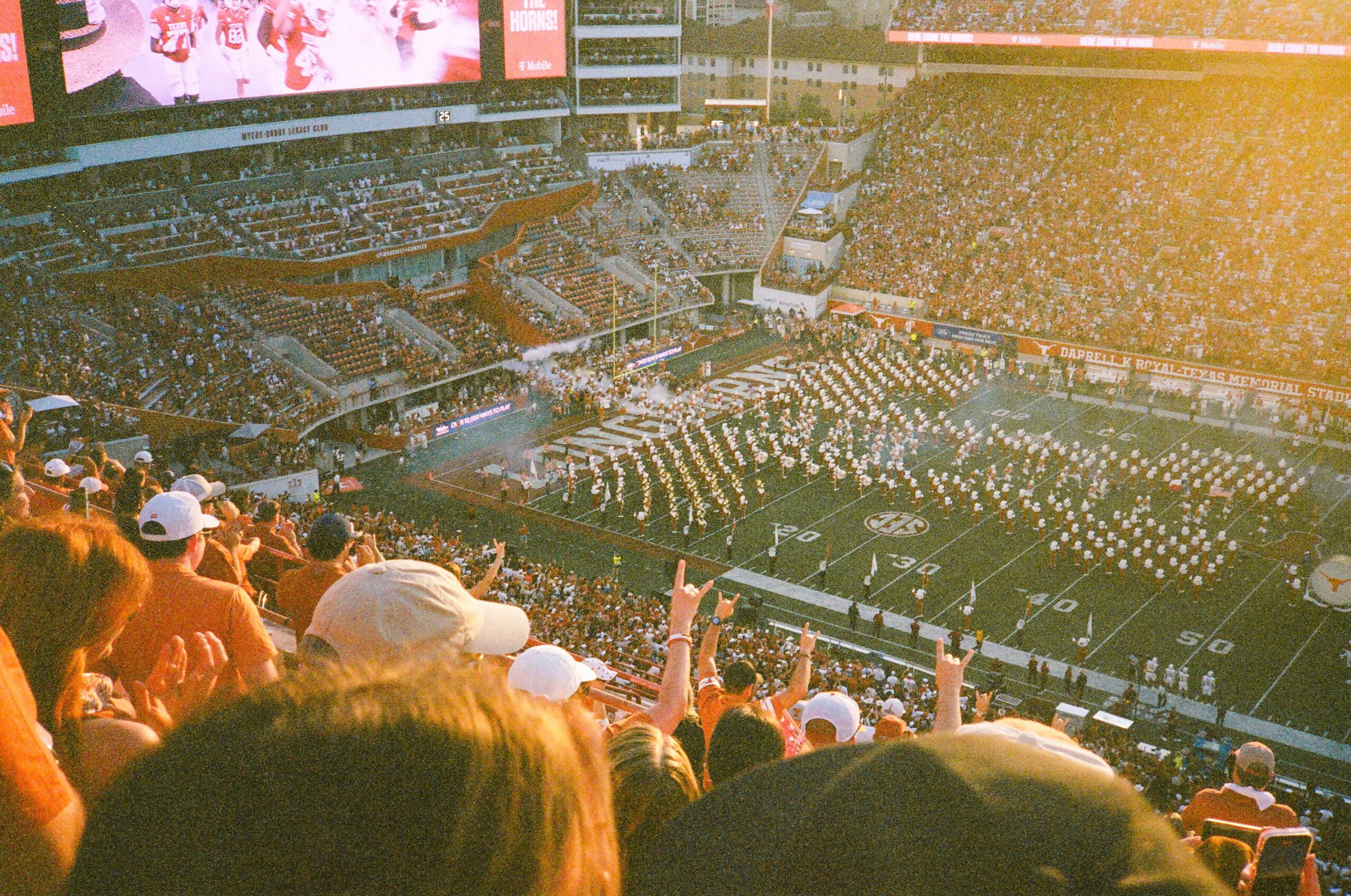 Film photo of players taking the field at a UT Game