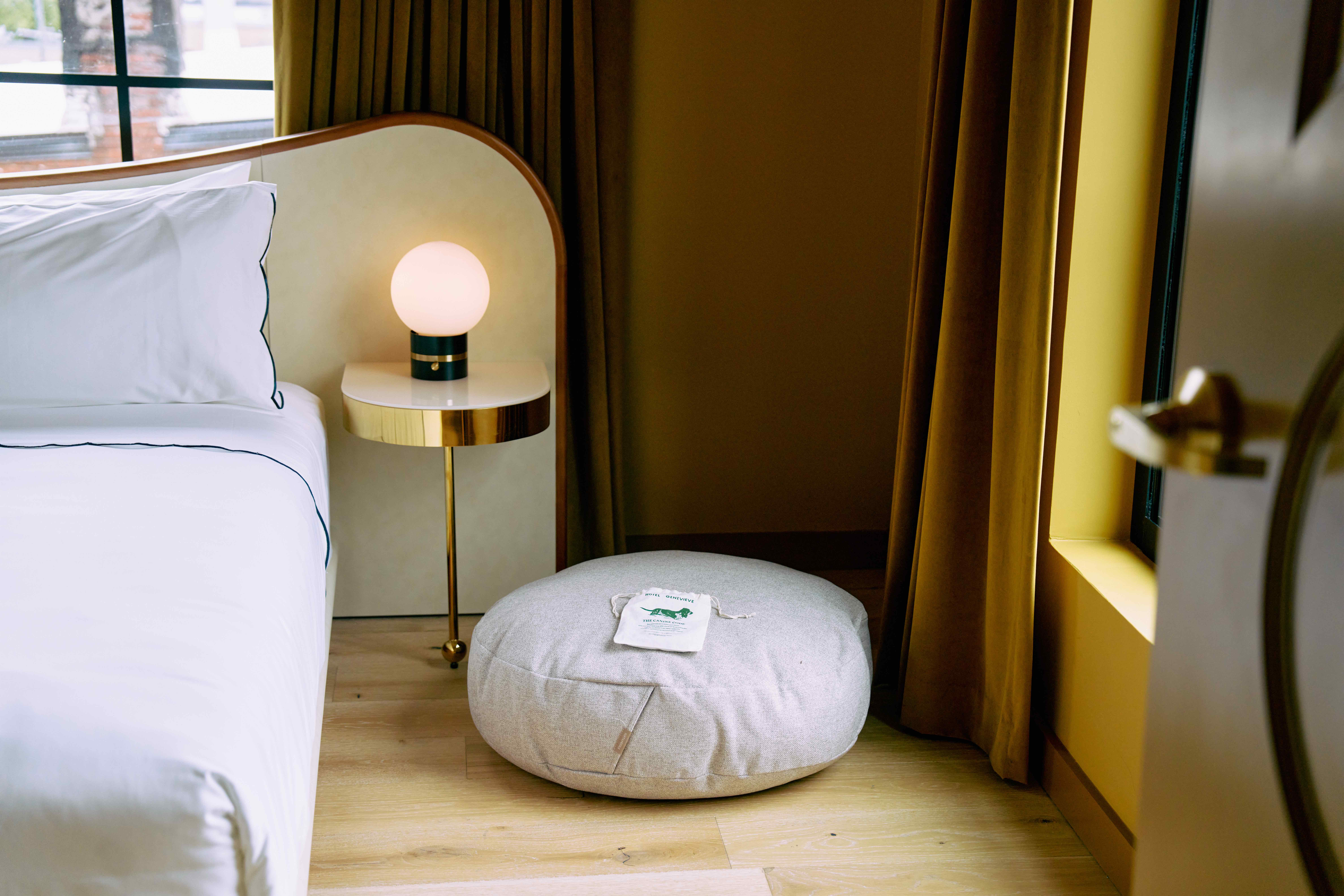 Dog bed in a yellow suite at Hotel Genevieve