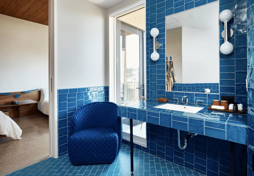 Blue tile bathroom with blue chair